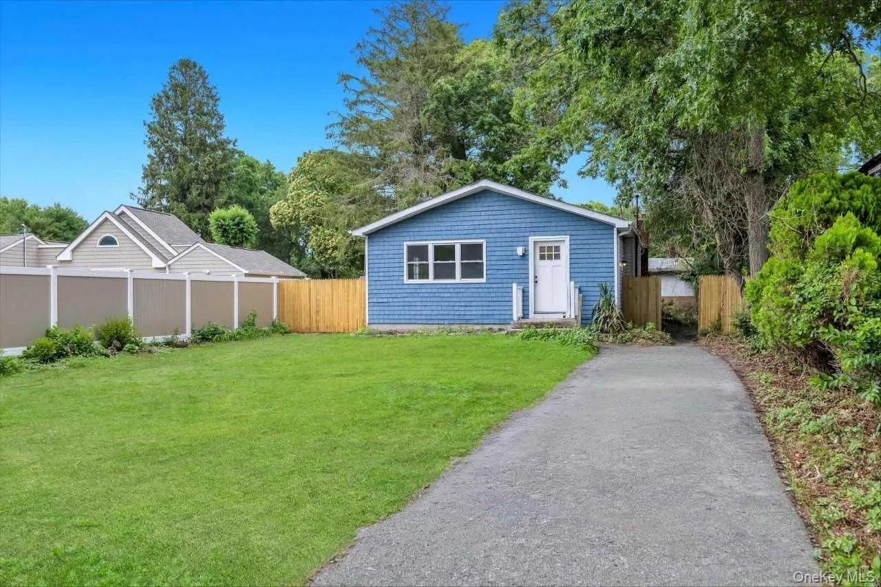Blue shingle-style siding exterior with white trim Blue shingle-style siding exterior with white trim