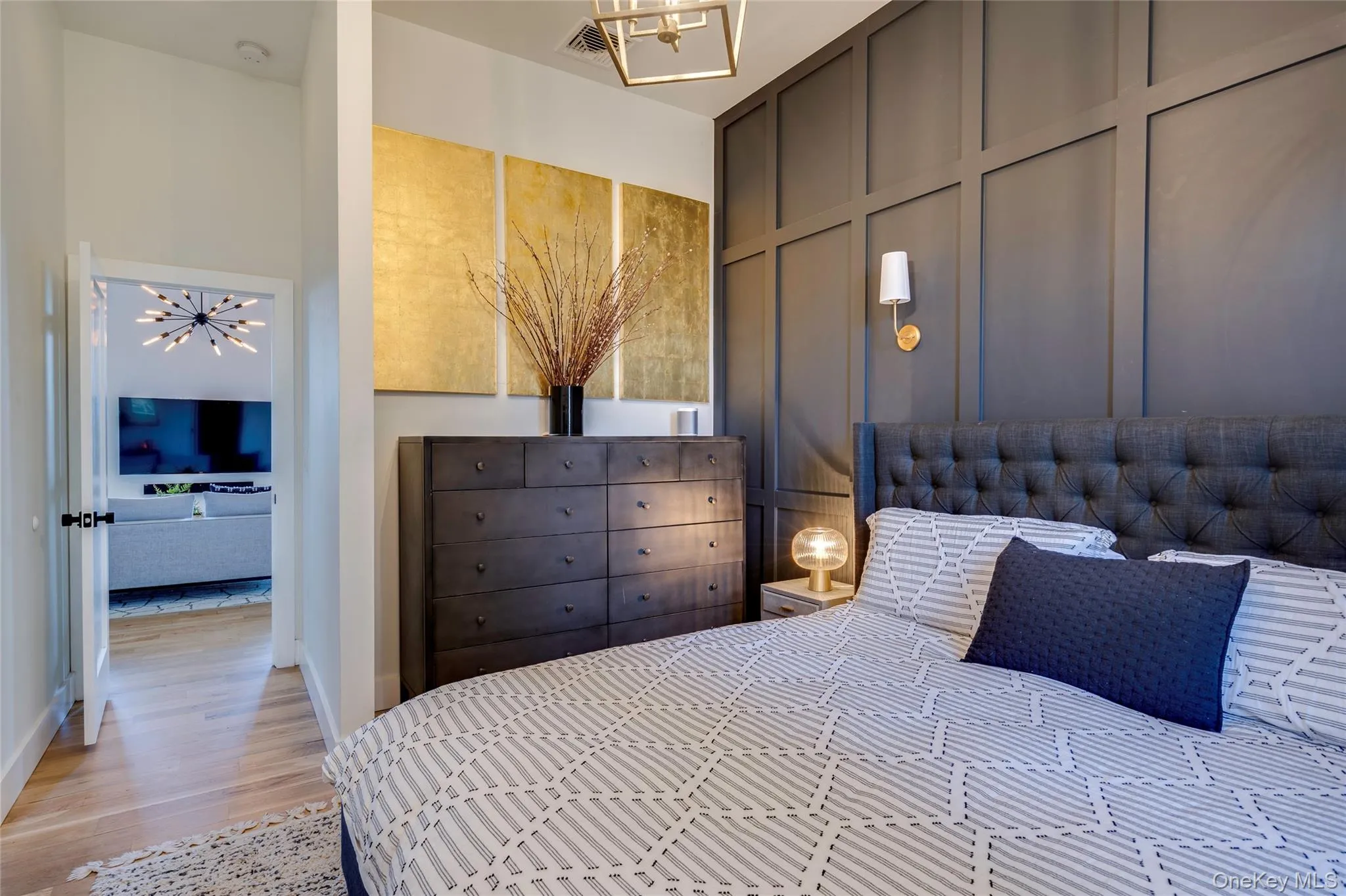 UpperAccent wall featuring dark paneling and a wall sconce UpperAccent wall featuring dark paneling and a wall sconce