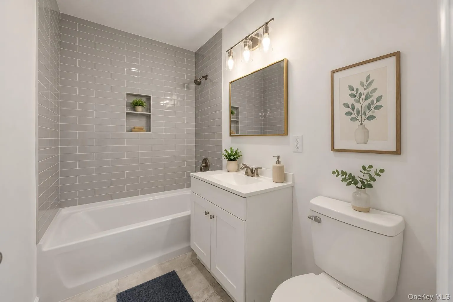 Bathroom featuring a white bathtub with subway tile surround, integrated shower niche, and bronze fixtures Bathroom featuring a white bathtub with subway tile surround, integrated shower niche, and bronze fixtures