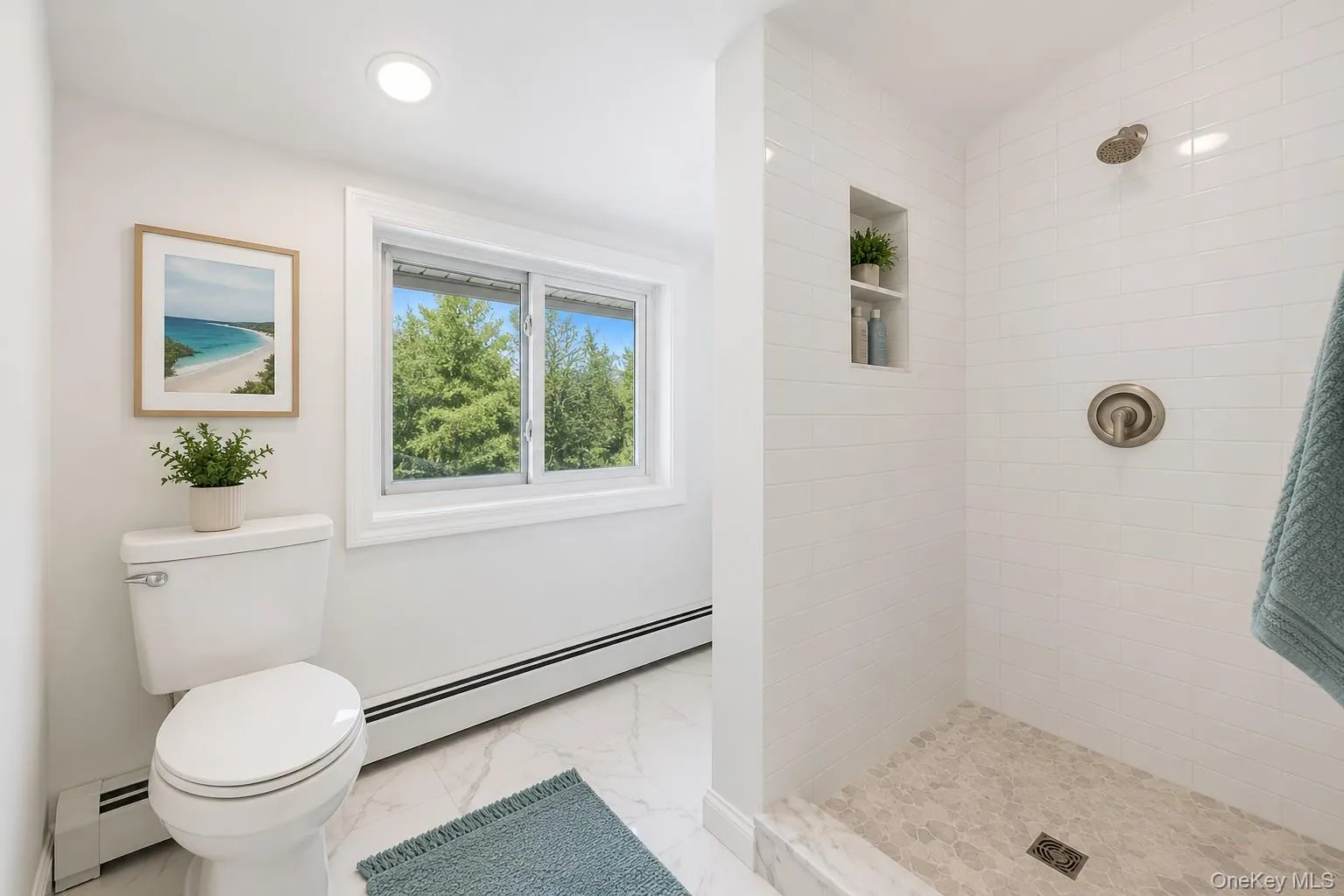 Bathroom featuring a walk-in shower with white subway tile, a recessed shower niche, and a brushed nickel rain shower head Bathroom featuring a walk-in shower with white subway tile, a recessed shower niche, and a brushed nickel rain shower head