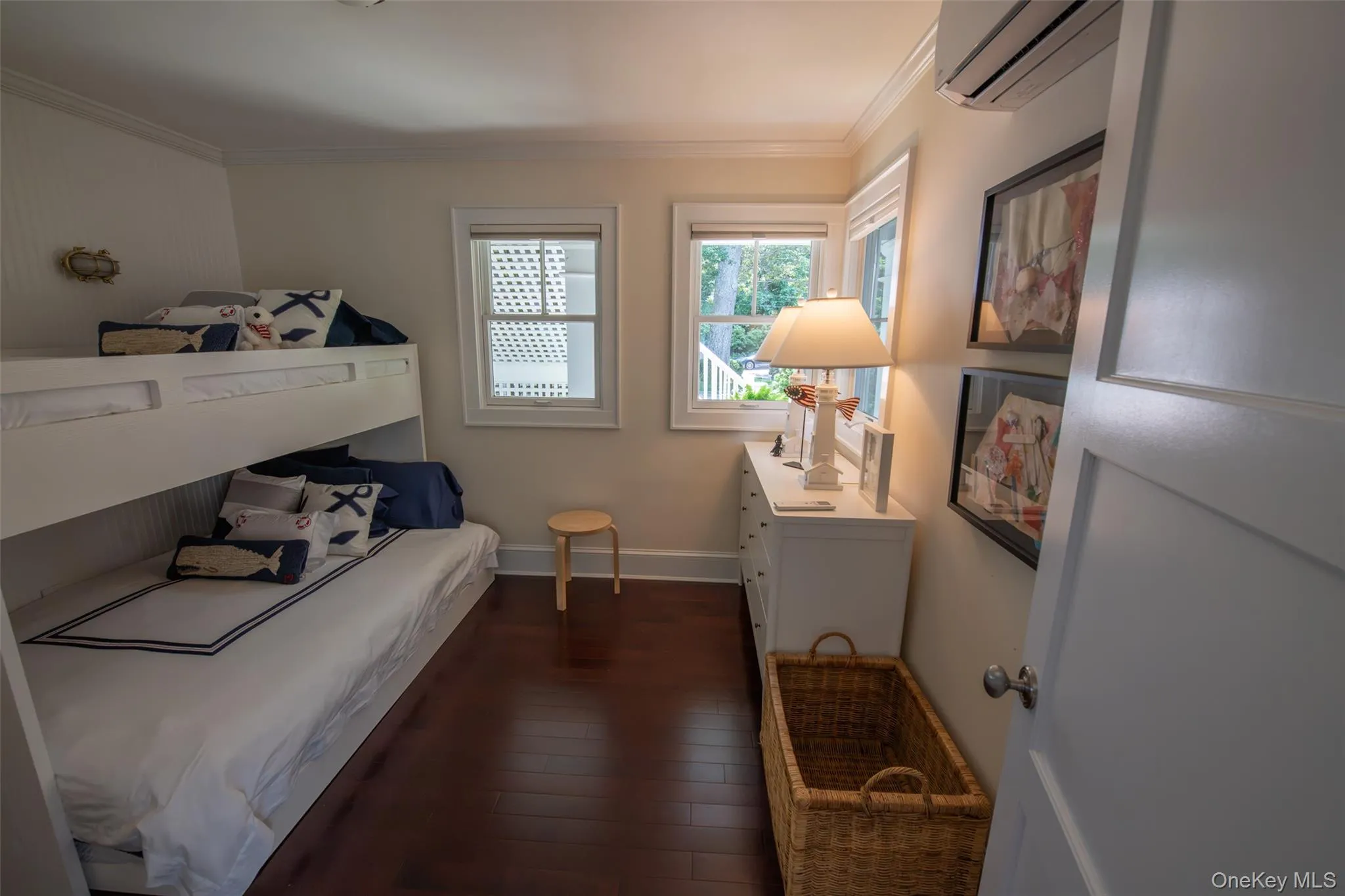 Fun bedroom featuring dark wood-finish flooring and a built-in bunk bed structure Fun bedroom featuring dark wood-finish flooring and a built-in bunk bed structure