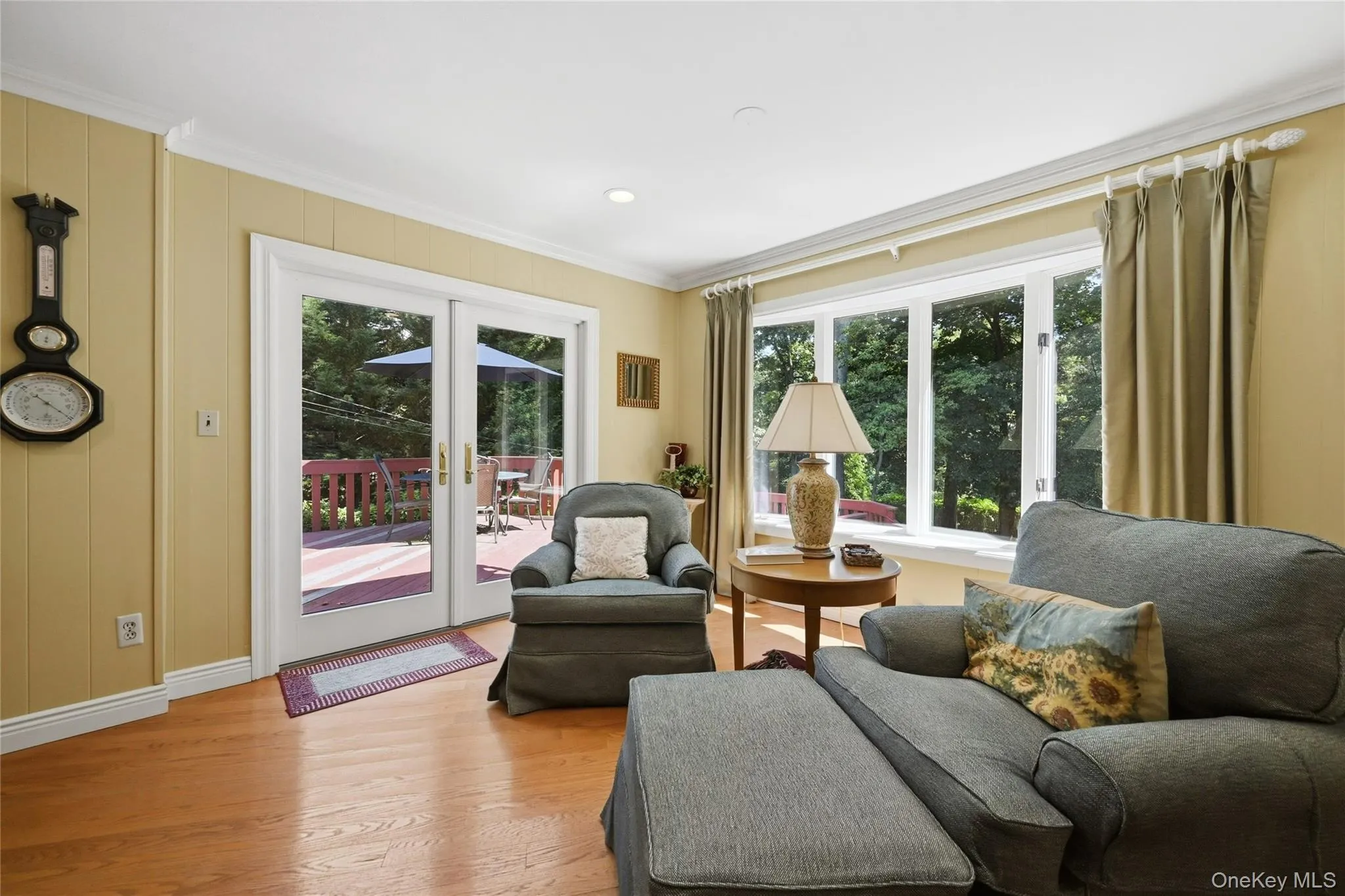 Reading area of living room, with French doors to back deck and yard Reading area of living room, with French doors to back deck and yard