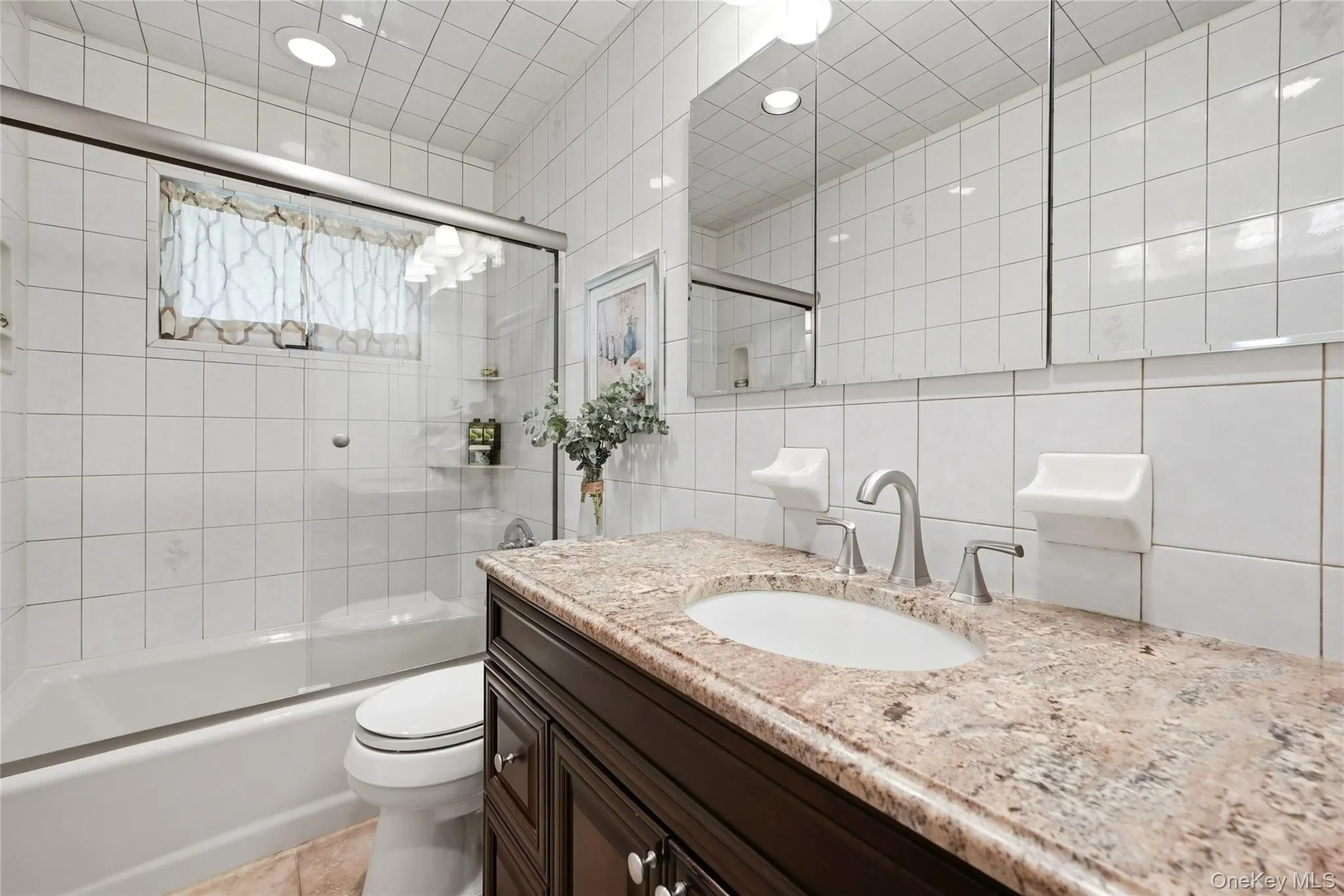 Full hallway bathroom with granite vanity and soaking tub Full hallway bathroom with granite vanity and soaking tub
