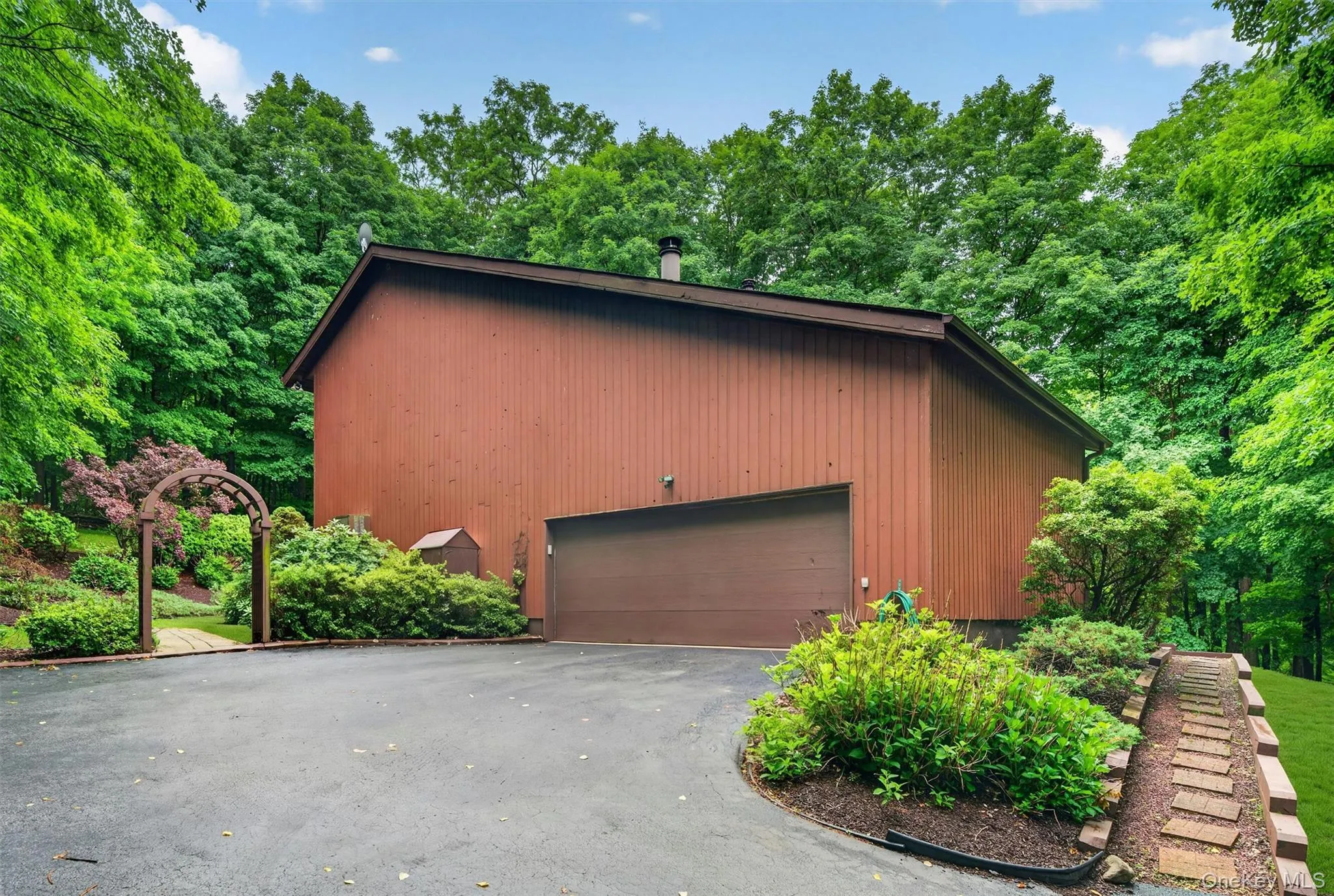 The large driveway is great for lots of cars. Look at quaint the walkway is The large driveway is great for lots of cars. Look at quaint the walkway is