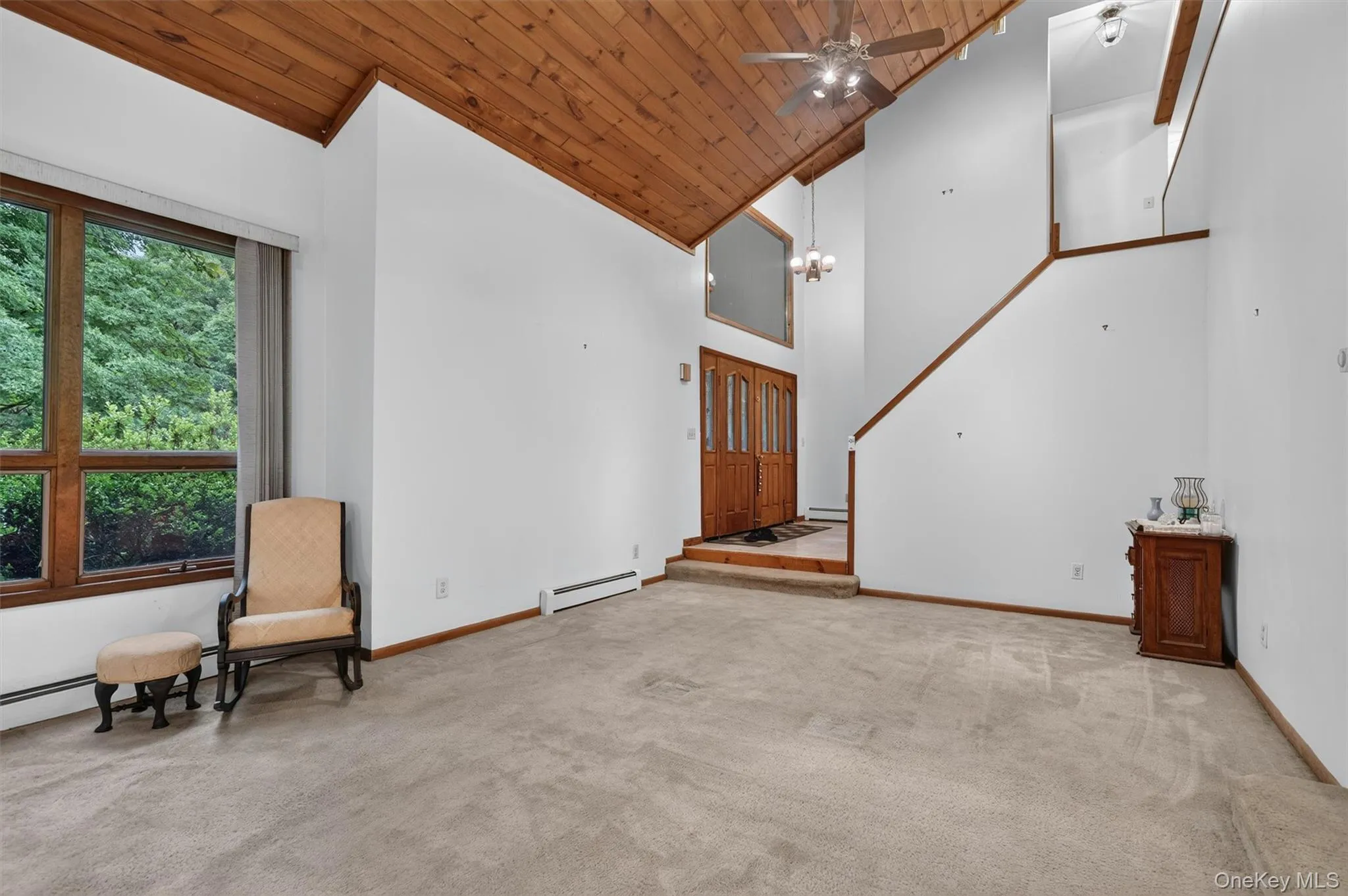 The living room makes a dramatic statement with the high wood ceiling. The living room makes a dramatic statement with the high wood ceiling.