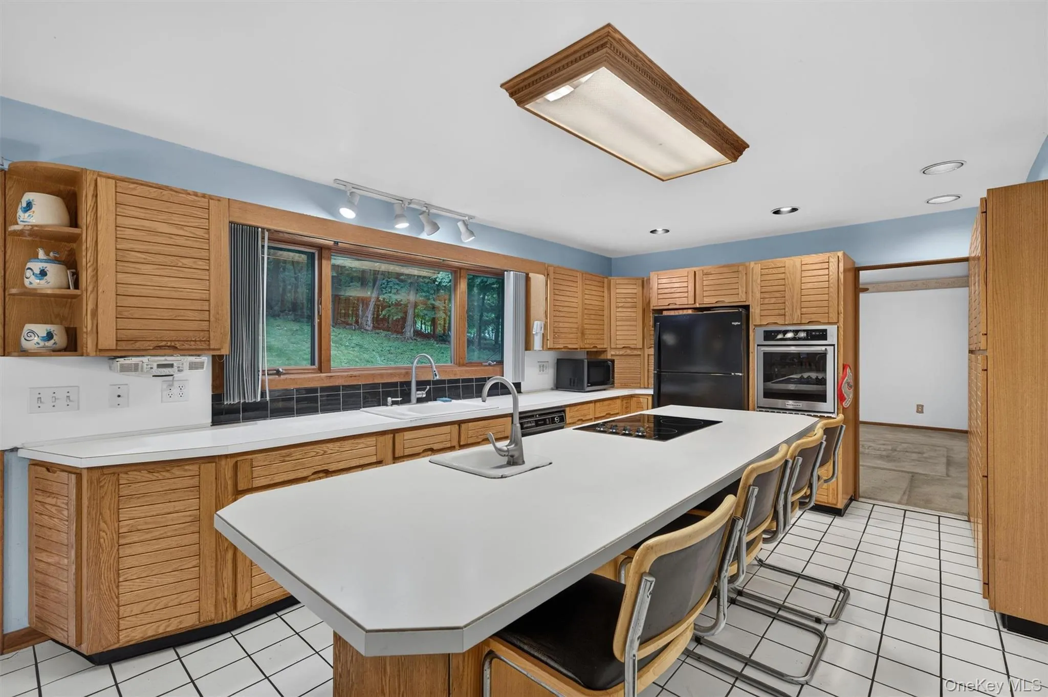 The cabinets are are sold wood in a retro shaker design. There is also wall oven The cabinets are are sold wood in a retro shaker design. There is also wall oven