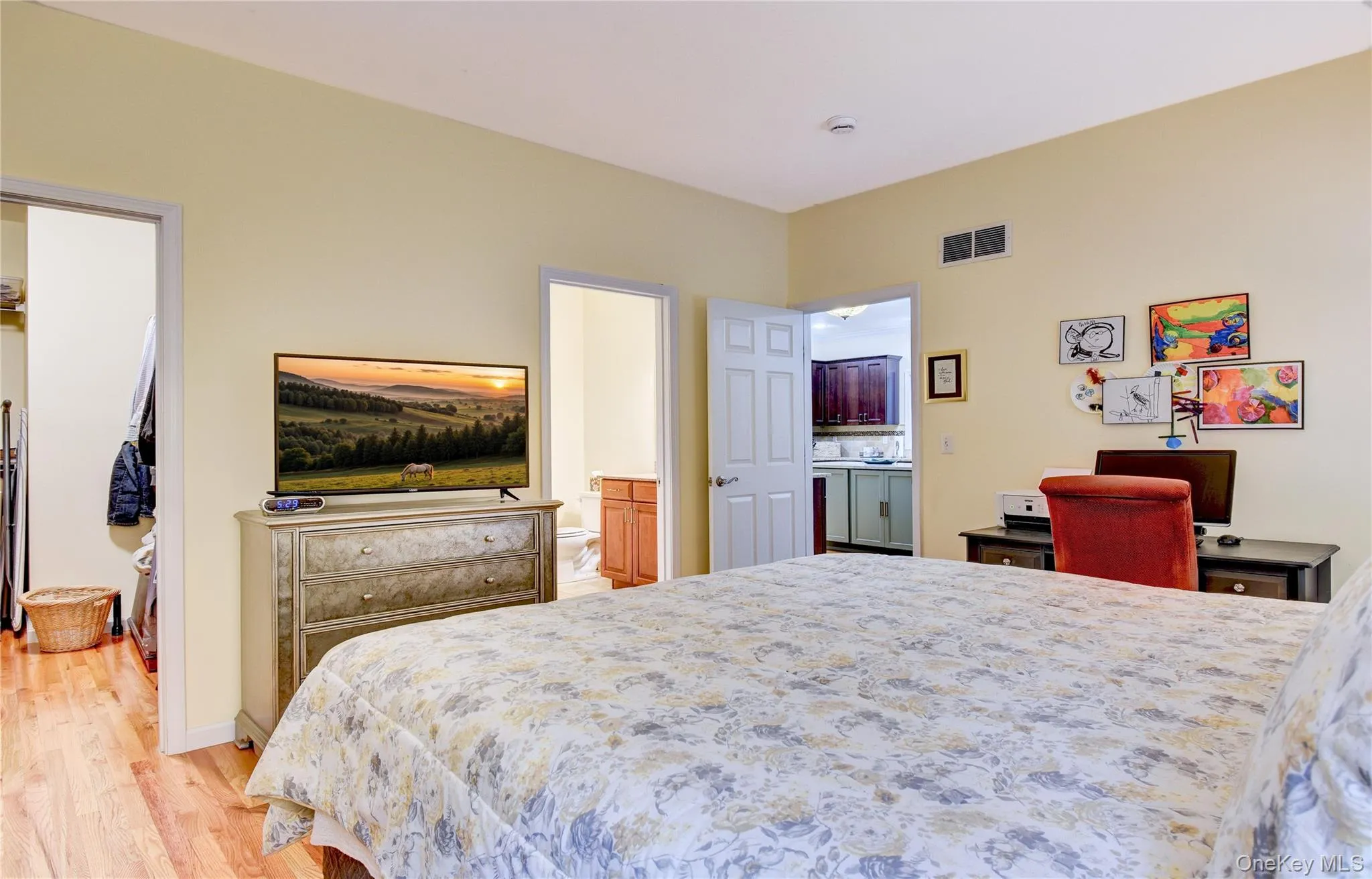 Legal accessory apartment: Bedroom featuring light yellow walls and wood flooring Legal accessory apartment: Bedroom featuring light yellow walls and wood flooring