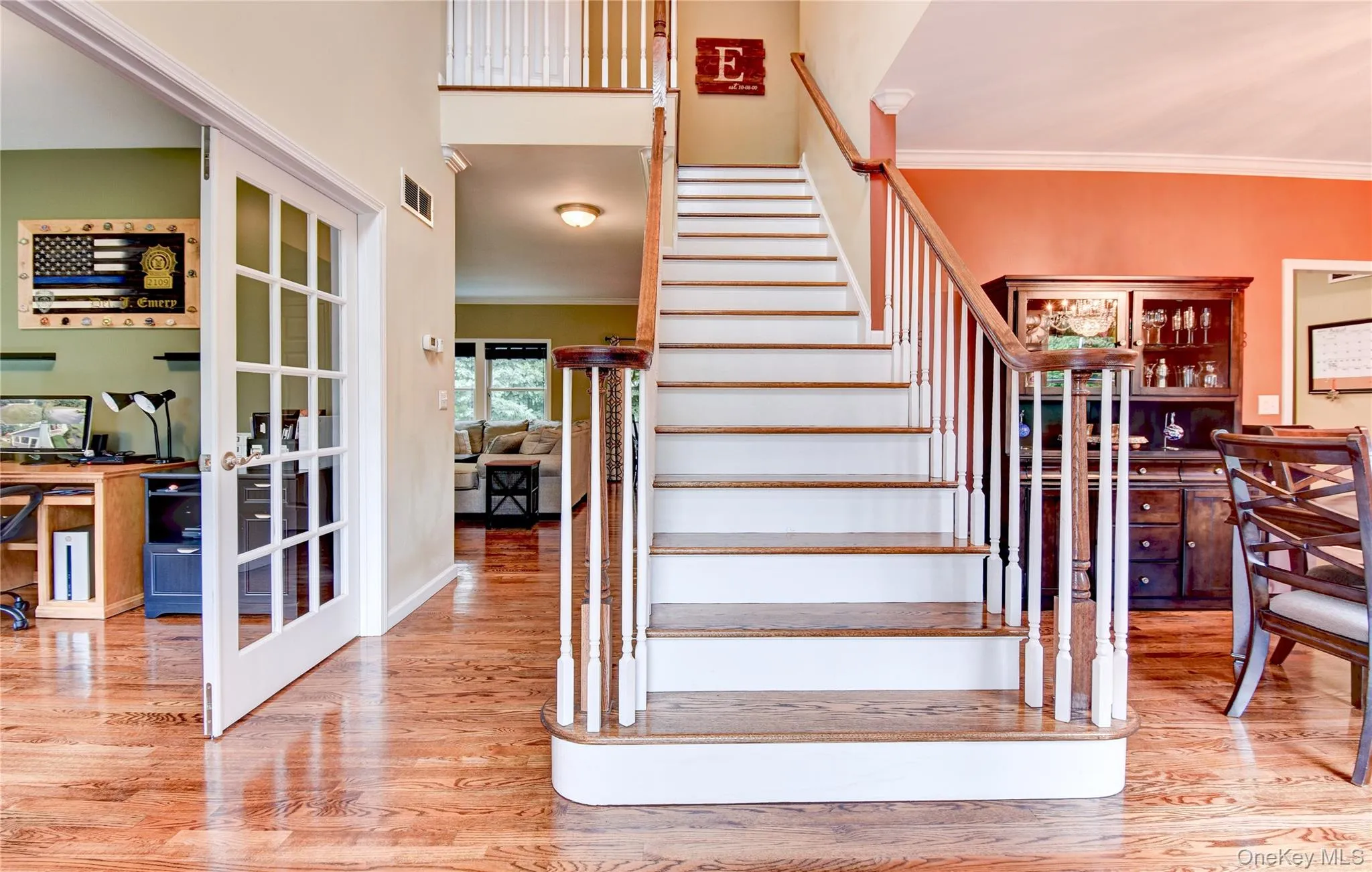 Grand staircase featuring wood treads and white risers Grand staircase featuring wood treads and white risers