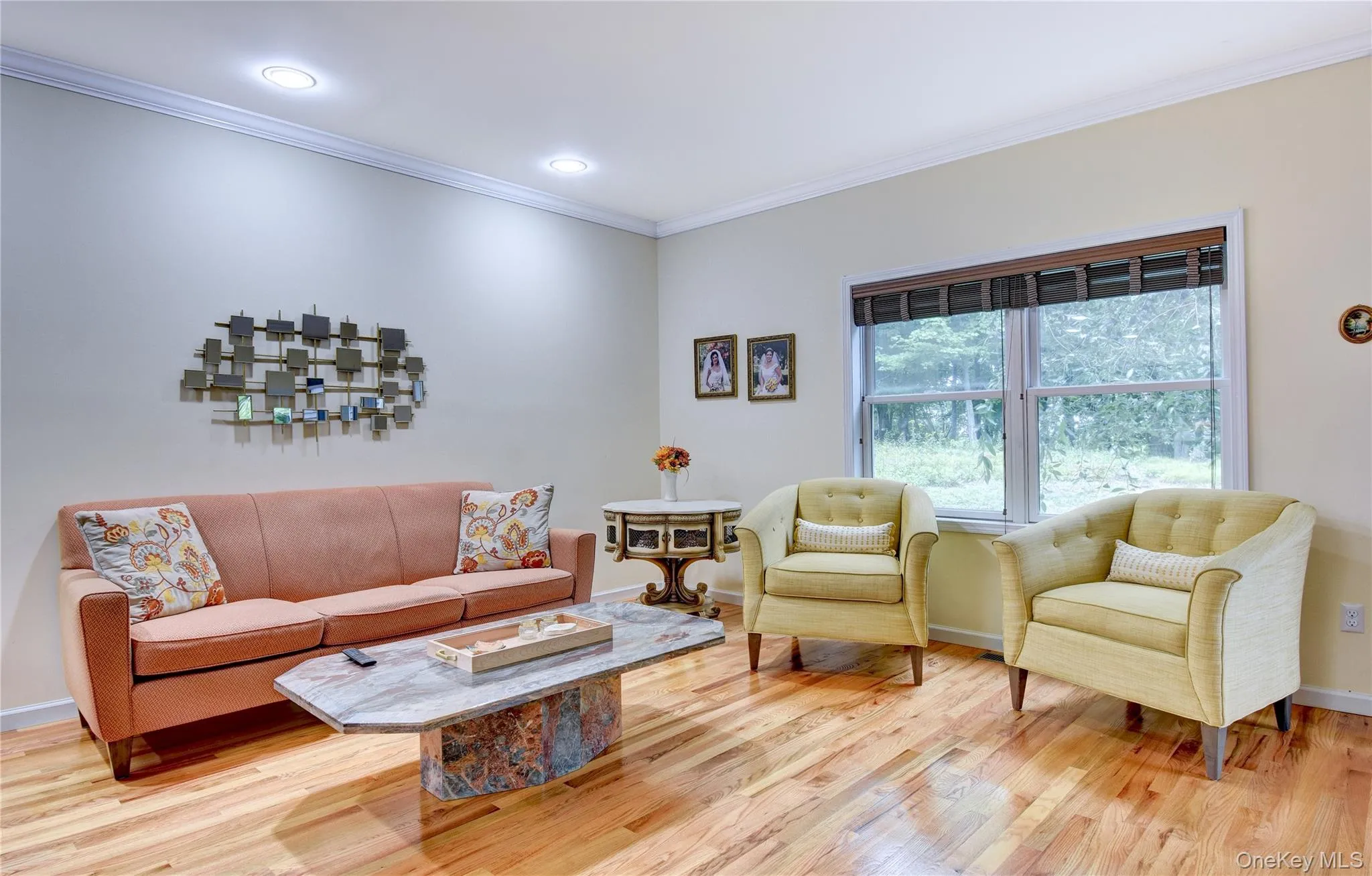 Legal accessory apartment: Bright living space featuring hardwood flooring, crown molding, recessed lighting, and a large window Legal accessory apartment: Bright living space featuring hardwood flooring, crown molding, recessed lighting, and a large window