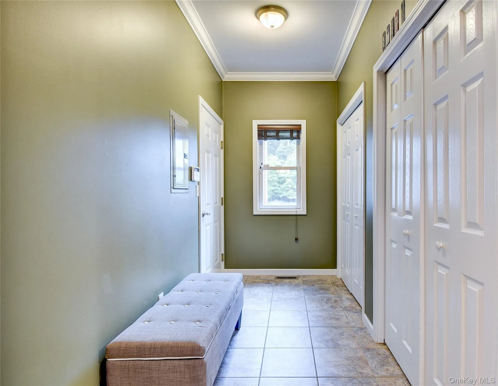 Hallway with entrance to garage and double pantries/closets Hallway with entrance to garage and double pantries/closets