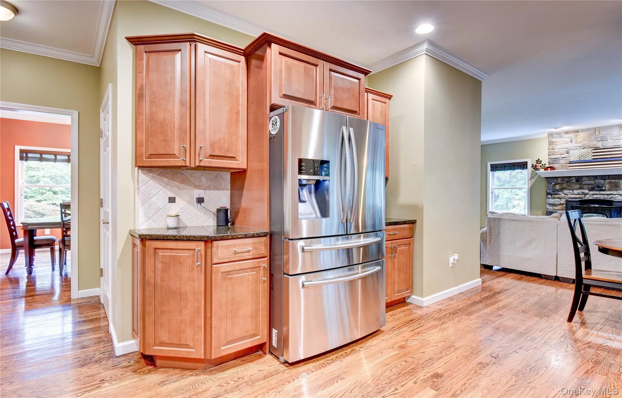 Stainless steel French door refrigerator, wood flooring, granite counters and crown molding Stainless steel French door refrigerator, wood flooring, granite counters and crown molding