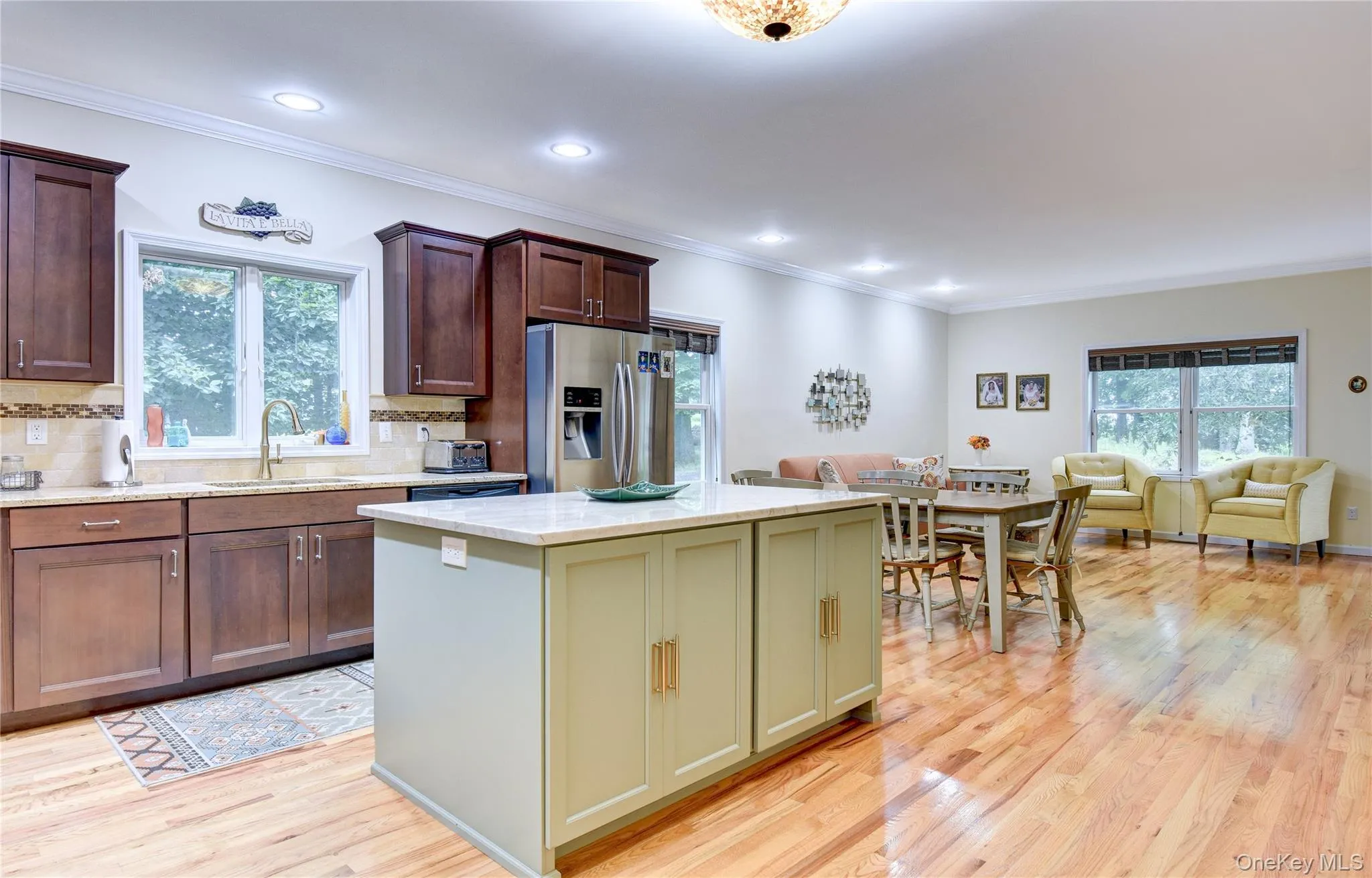 Legal accessory apartment: Open-concept living space featuring wood flooring, recessed lighting, and crown molding Legal accessory apartment: Open-concept living space featuring wood flooring, recessed lighting, and crown molding