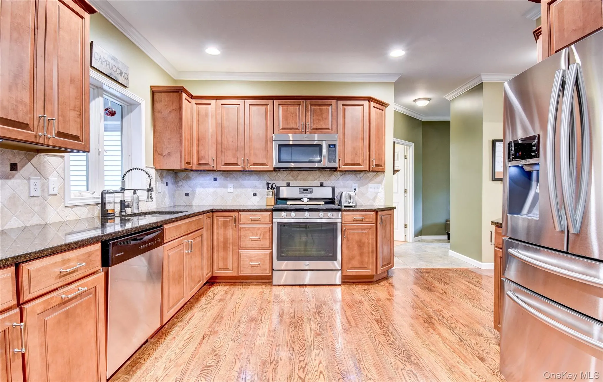 Kitchen featuring wood flooring, recessed lighting, granite counters, and crown molding Kitchen featuring wood flooring, recessed lighting, granite counters, and crown molding