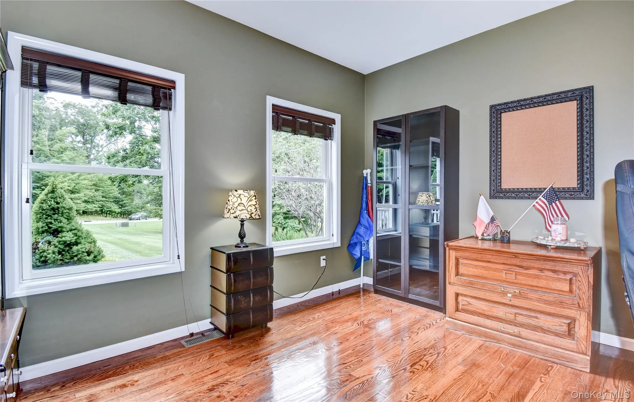 Office featuring wood flooring, two windows and french doors Office featuring wood flooring, two windows and french doors