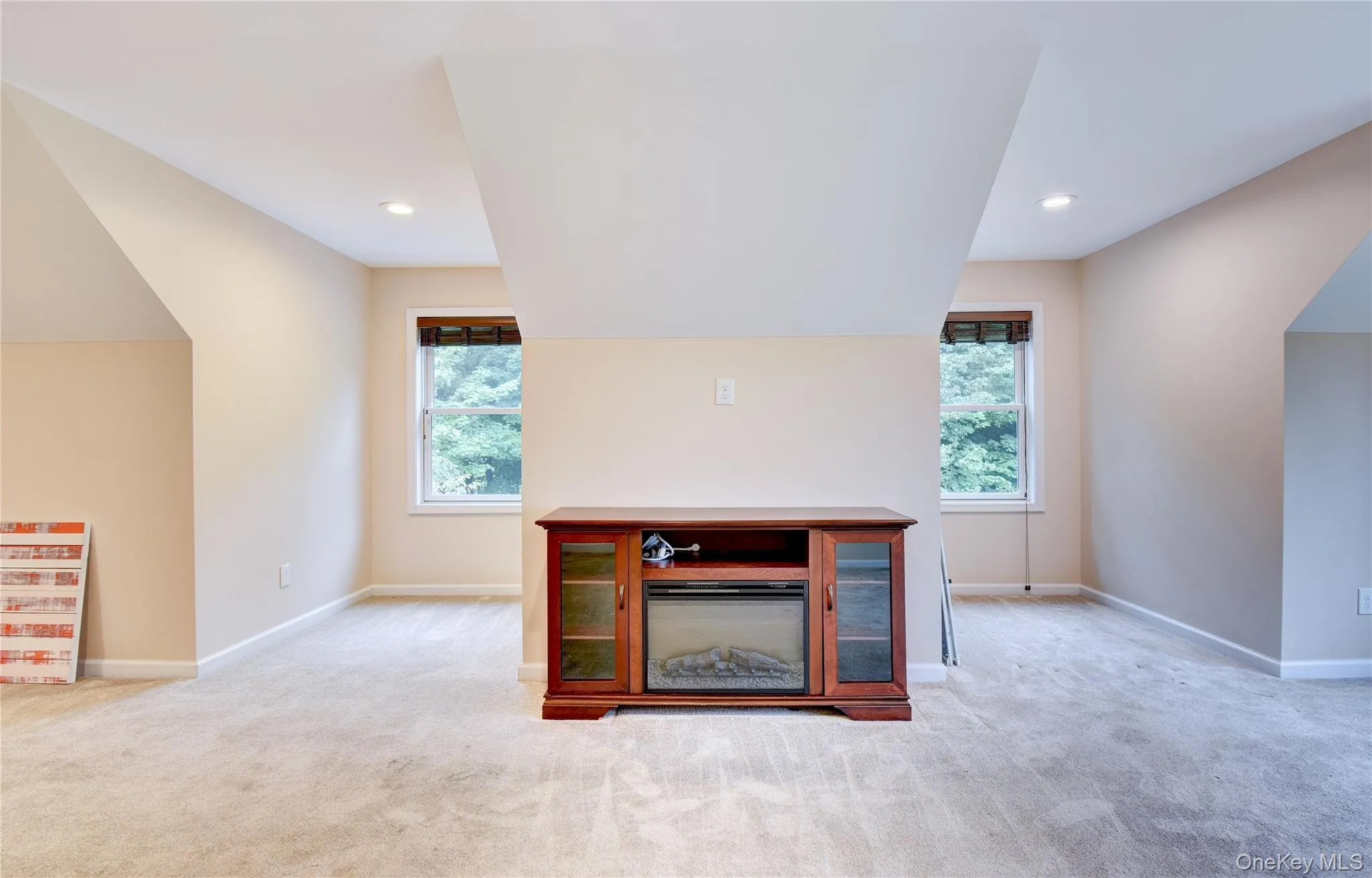 Carpeted bonus room with sloped ceilings and recessed lighting Carpeted bonus room with sloped ceilings and recessed lighting