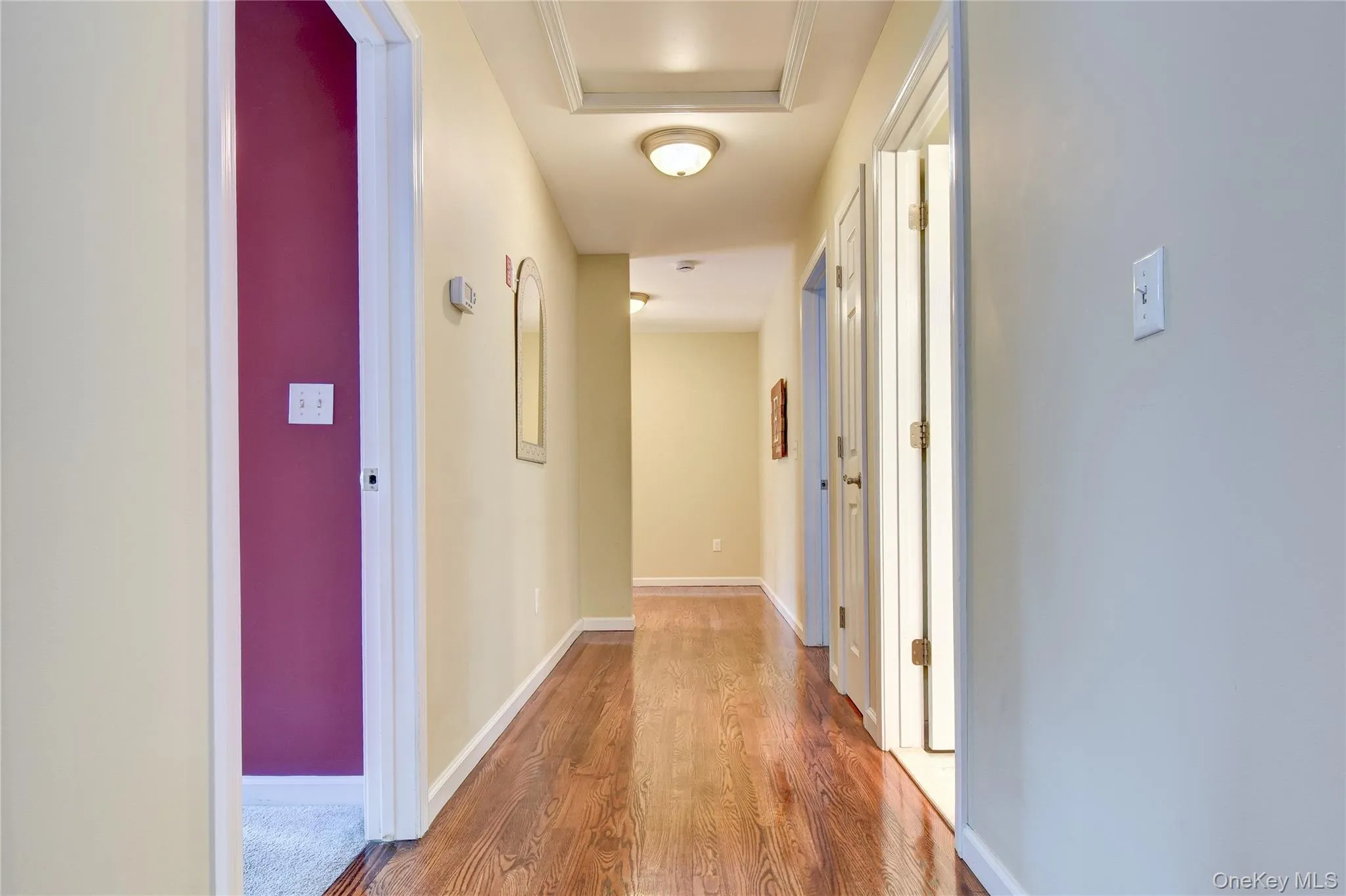 Hallway featuring wood flooring Hallway featuring wood flooring