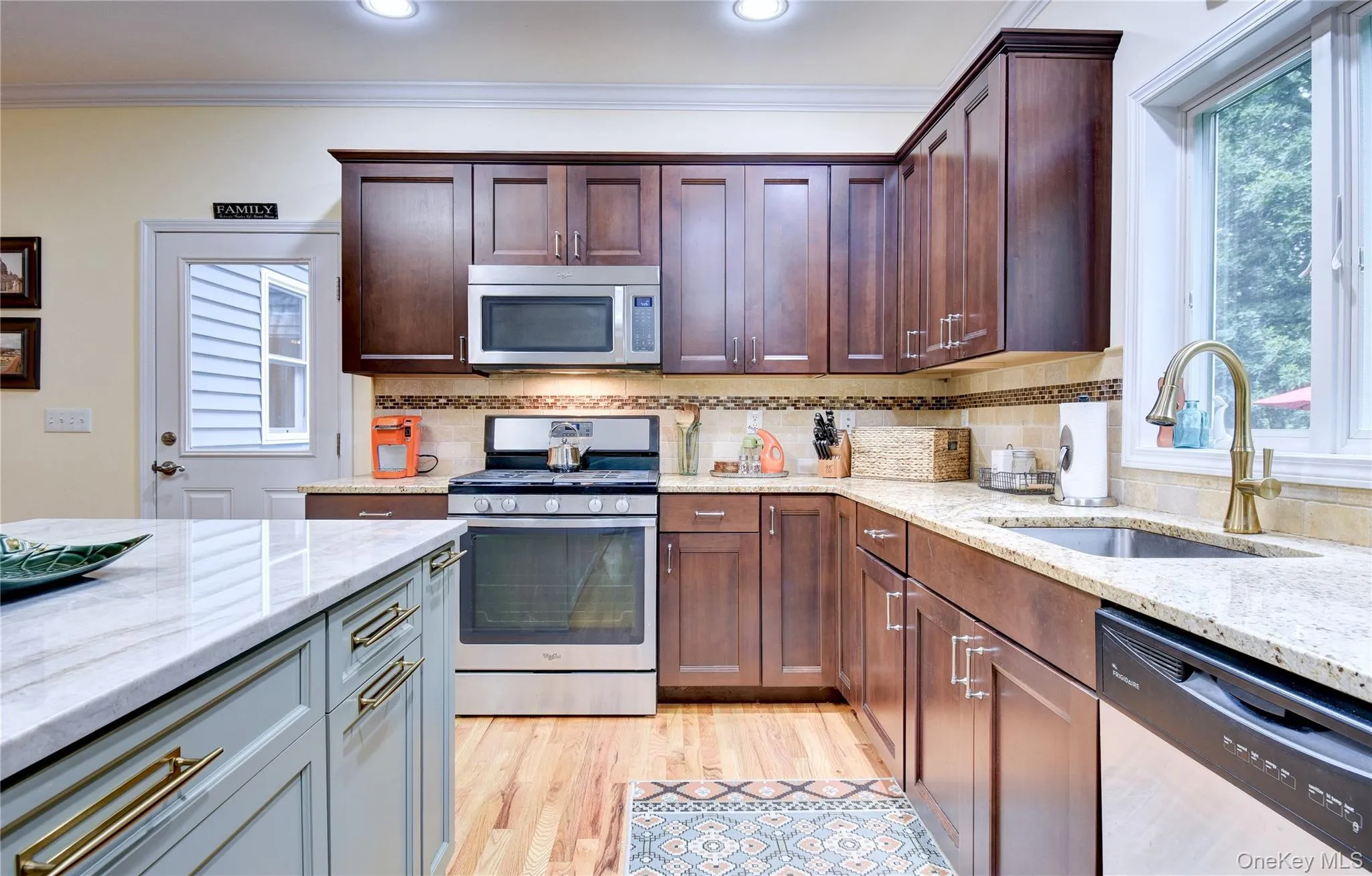 Legal accessory apartment: Kitchen featuring wood flooring, dark wood cabinetry Legal accessory apartment: Kitchen featuring wood flooring, dark wood cabinetry