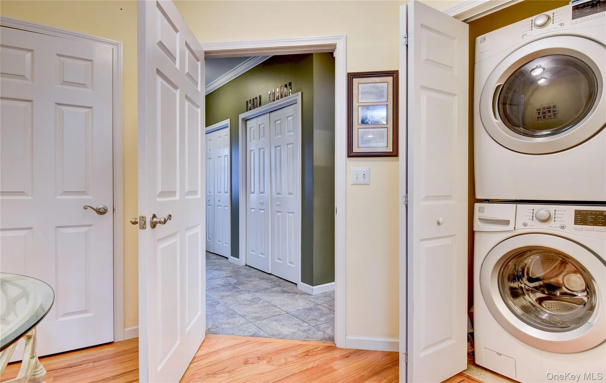 Legal accessory apartment: laundry area featuring a stacked washer and dryer unit Legal accessory apartment: laundry area featuring a stacked washer and dryer unit
