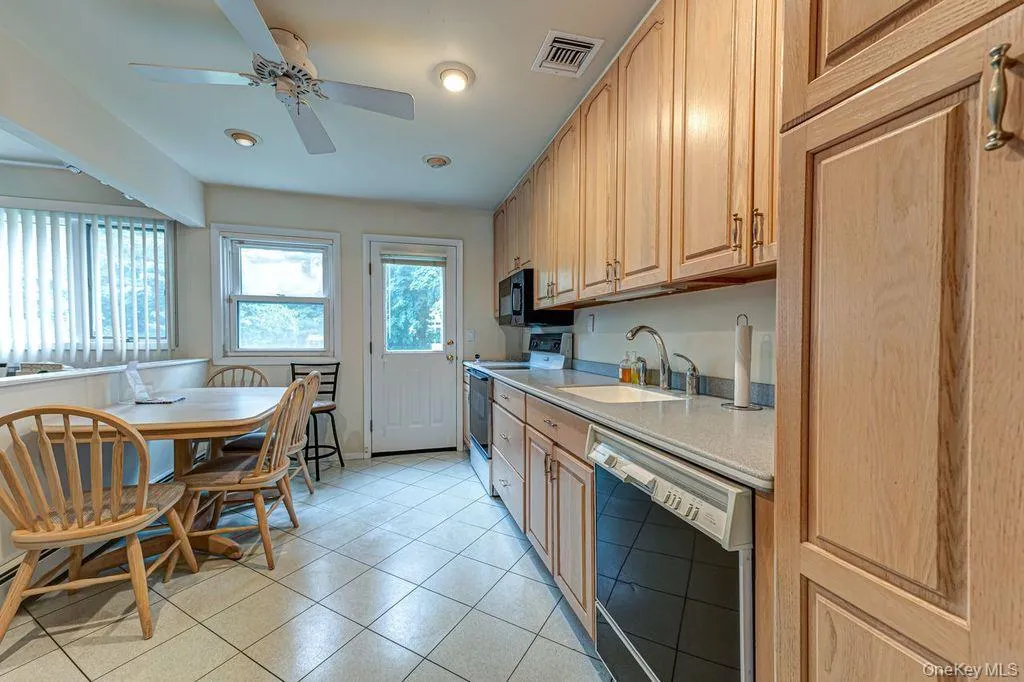 Wood cabinets spacious eating area. Open to dining room Wood cabinets spacious eating area. Open to dining room