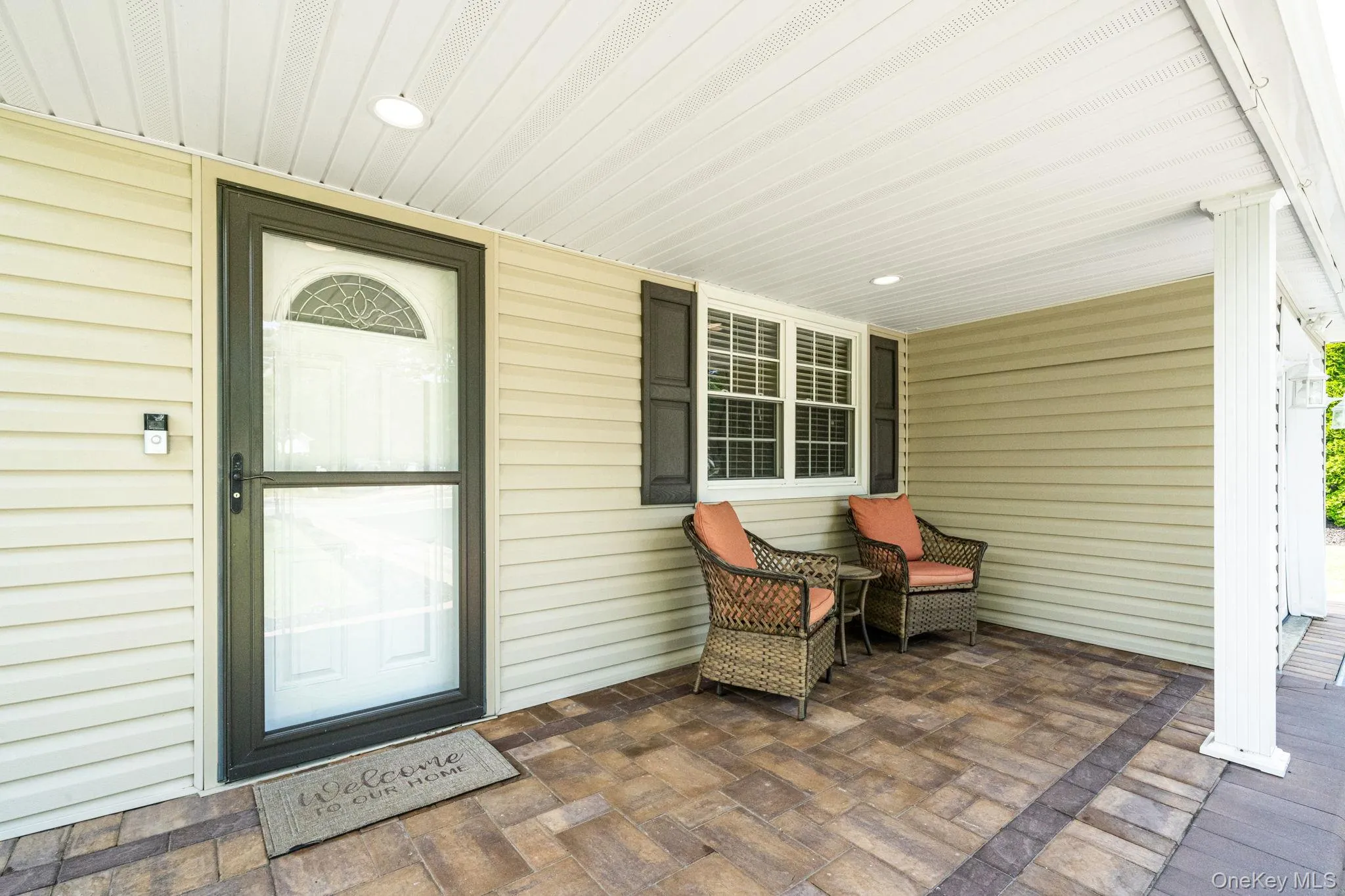 Welcoming covered front porch with, Cambridge pavers and recessed lighting Welcoming covered front porch with, Cambridge pavers and recessed lighting