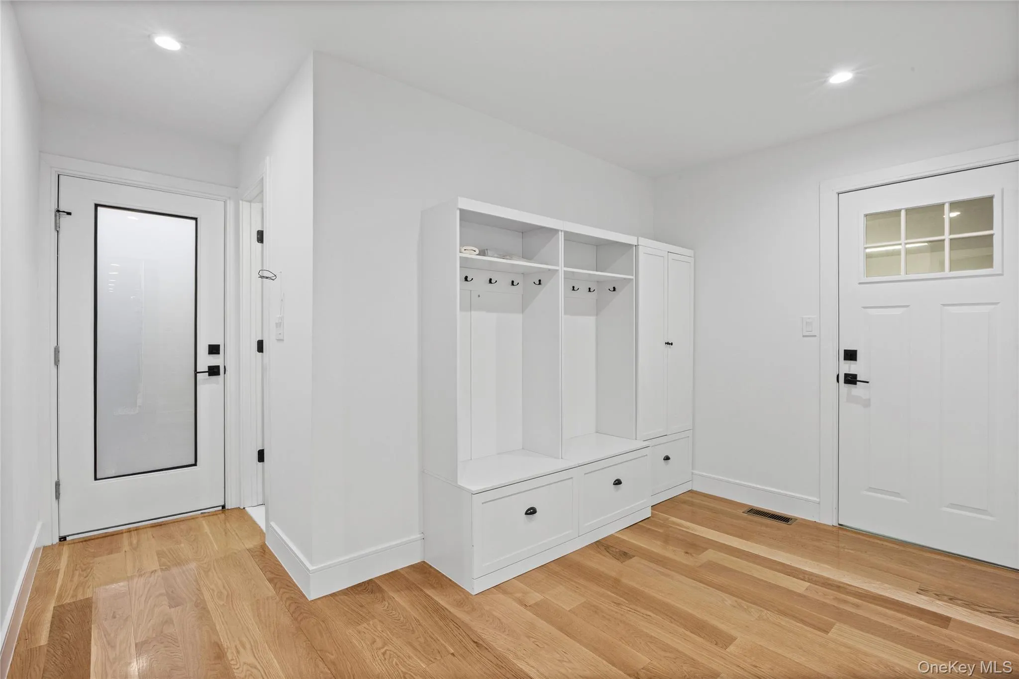 Entryway featuring warm wood-finish flooring and recessed lighting Entryway featuring warm wood-finish flooring and recessed lighting