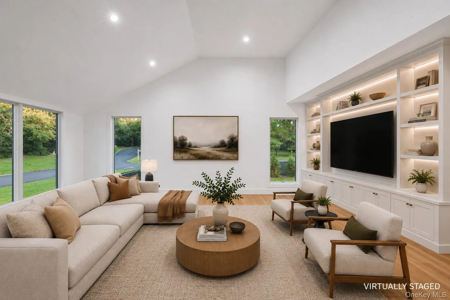 Spacious living area featuring a vaulted ceiling, recessed lighting, expansive windows, light wood-finish flooring, Virtually staged. Spacious living area featuring a vaulted ceiling, recessed lighting, expansive windows, light wood-finish flooring, Virtually staged.
