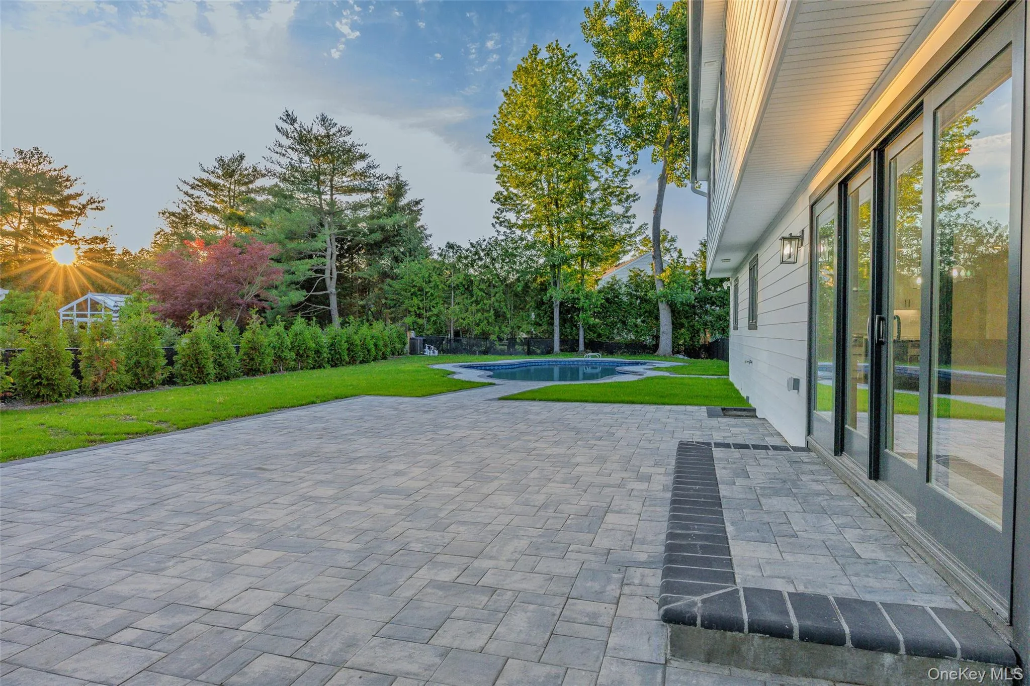 Expansive paver patio with a dark brick border Expansive paver patio with a dark brick border