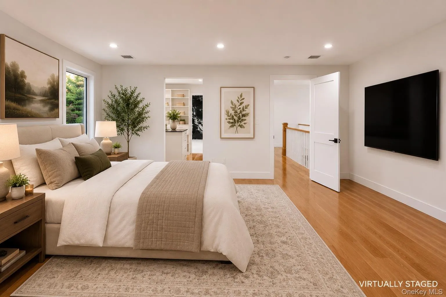Bedroom featuring hardwood flooring, recessed lighting, and a white interior door with black hardware Bedroom featuring hardwood flooring, recessed lighting, and a white interior door with black hardware