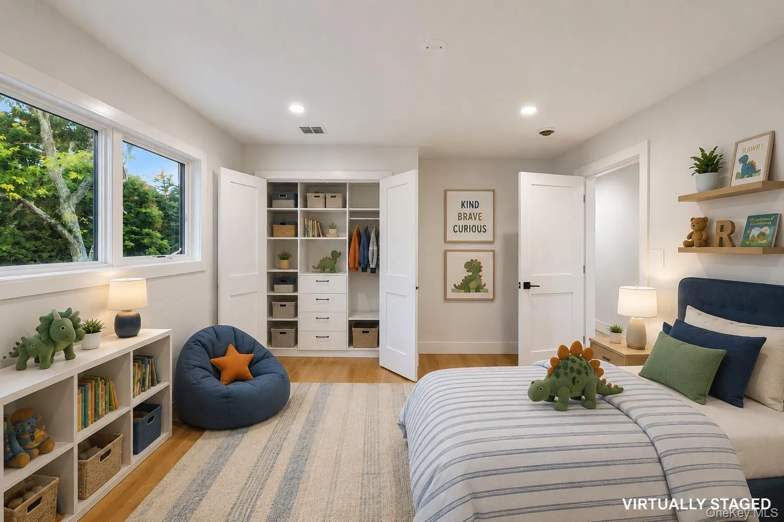 Room featuring wood-finish flooring, recessed lighting, and a custom built-in closet system with shelving and drawers. Virtually Staged. Room featuring wood-finish flooring, recessed lighting, and a custom built-in closet system with shelving and drawers. Virtually Staged.