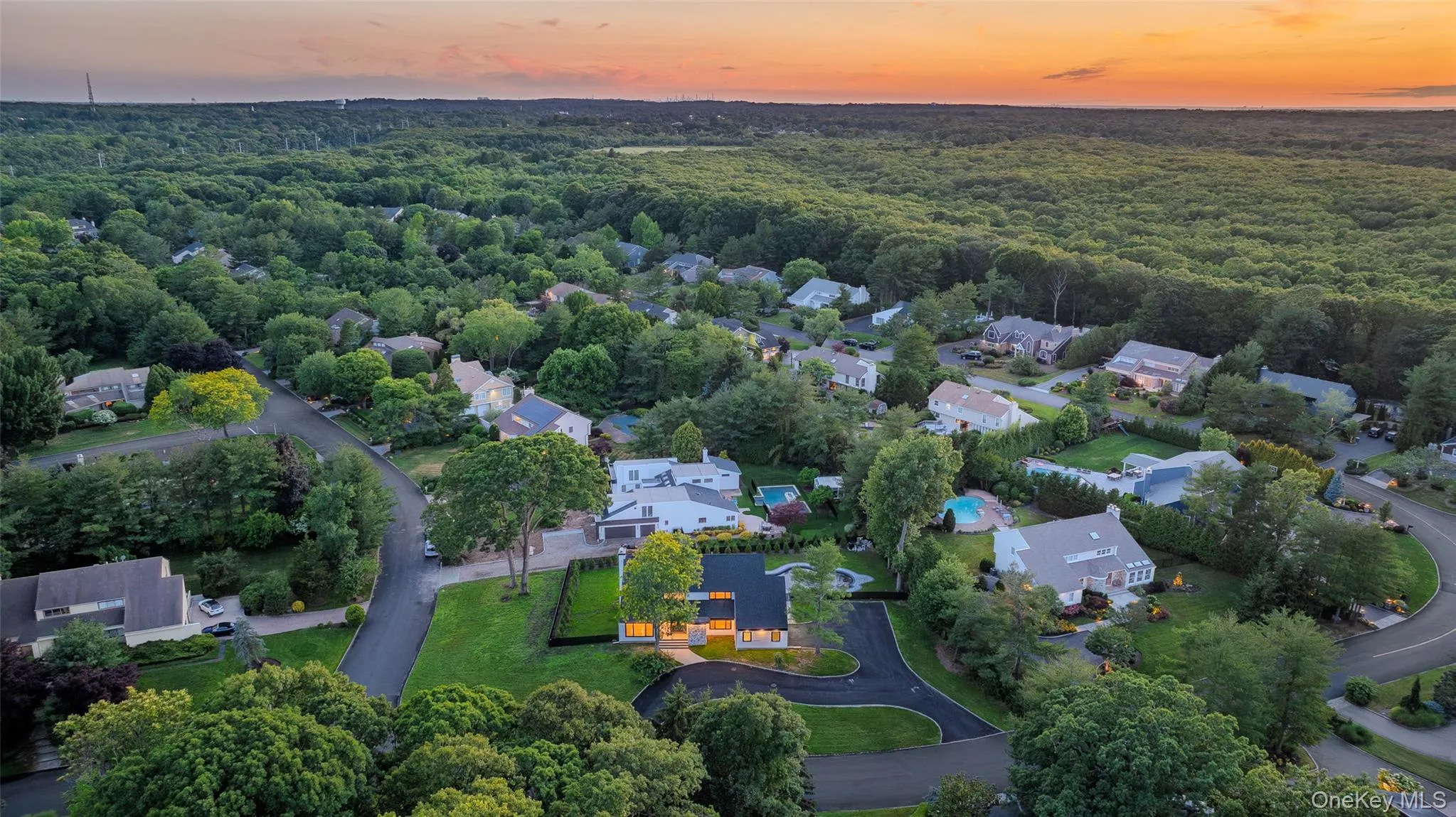 Aerial perspective showcasing a residential neighborhood with extensive mature tree coverage Aerial perspective showcasing a residential neighborhood with extensive mature tree coverage