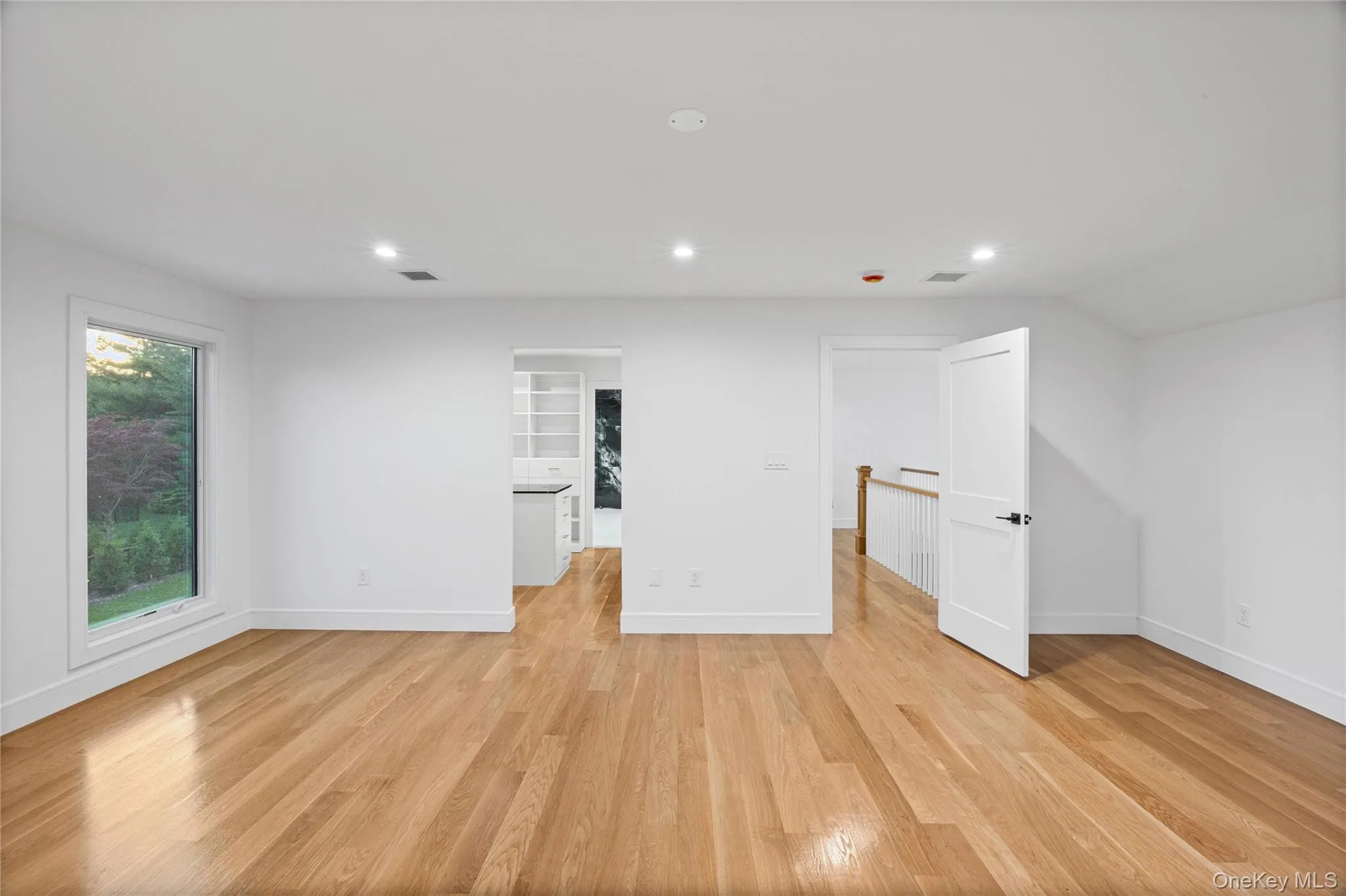 Spacious Primary Bedroom featuring hardwood flooring, multiple windows, walk in closet and walk in bathroom. Spacious Primary Bedroom featuring hardwood flooring, multiple windows, walk in closet and walk in bathroom.