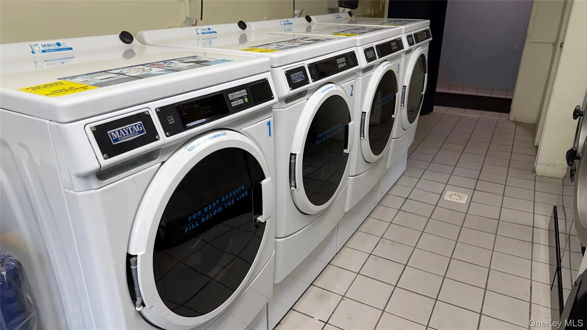 Shared laundry room featuring washing machine and clothes dryer Shared laundry room featuring washing machine and clothes dryer