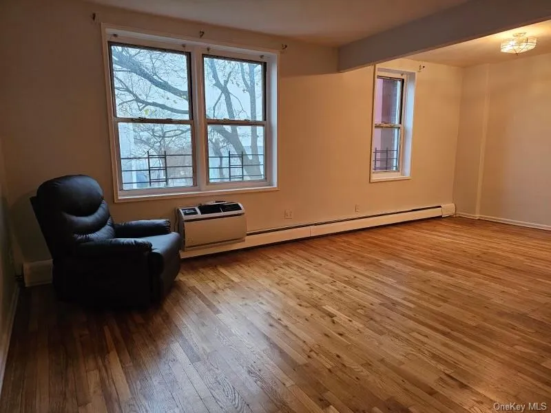 Sitting room featuring light wood-type flooring and baseboard heating Sitting room featuring light wood-type flooring and baseboard heating