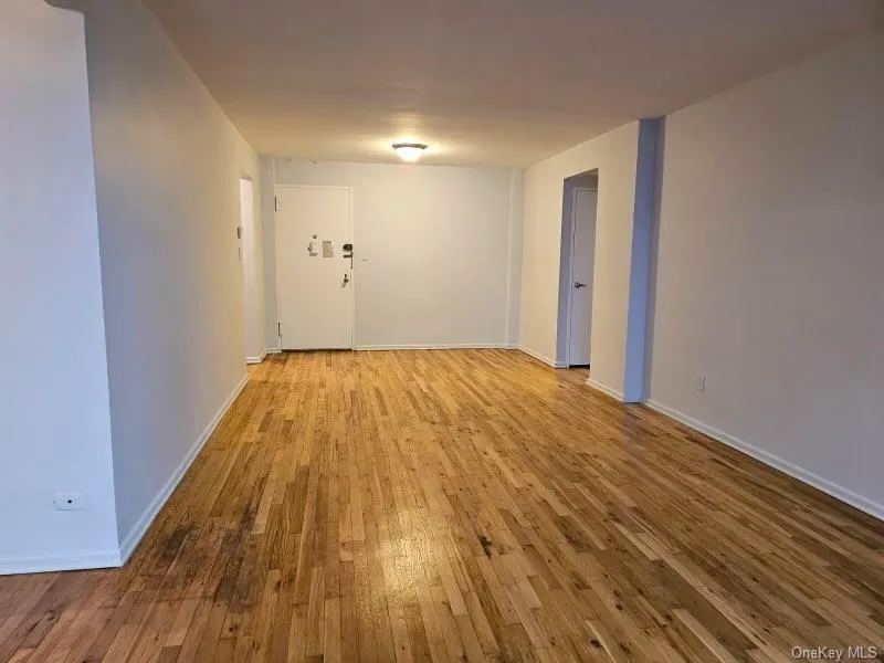 Empty room with light wood-type flooring and baseboards Empty room with light wood-type flooring and baseboards