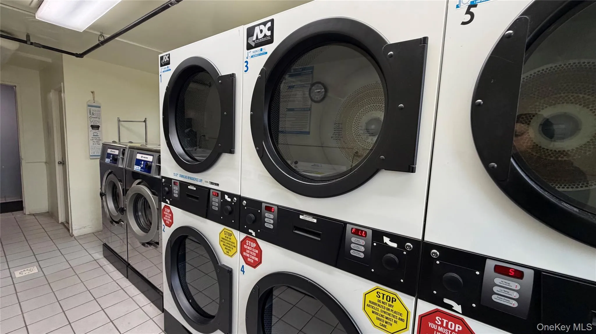 Communal laundry room featuring stacked washing machine and dryer Communal laundry room featuring stacked washing machine and dryer