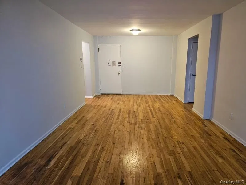 Empty room with hardwood / wood-style floors and baseboards Empty room with hardwood / wood-style floors and baseboards