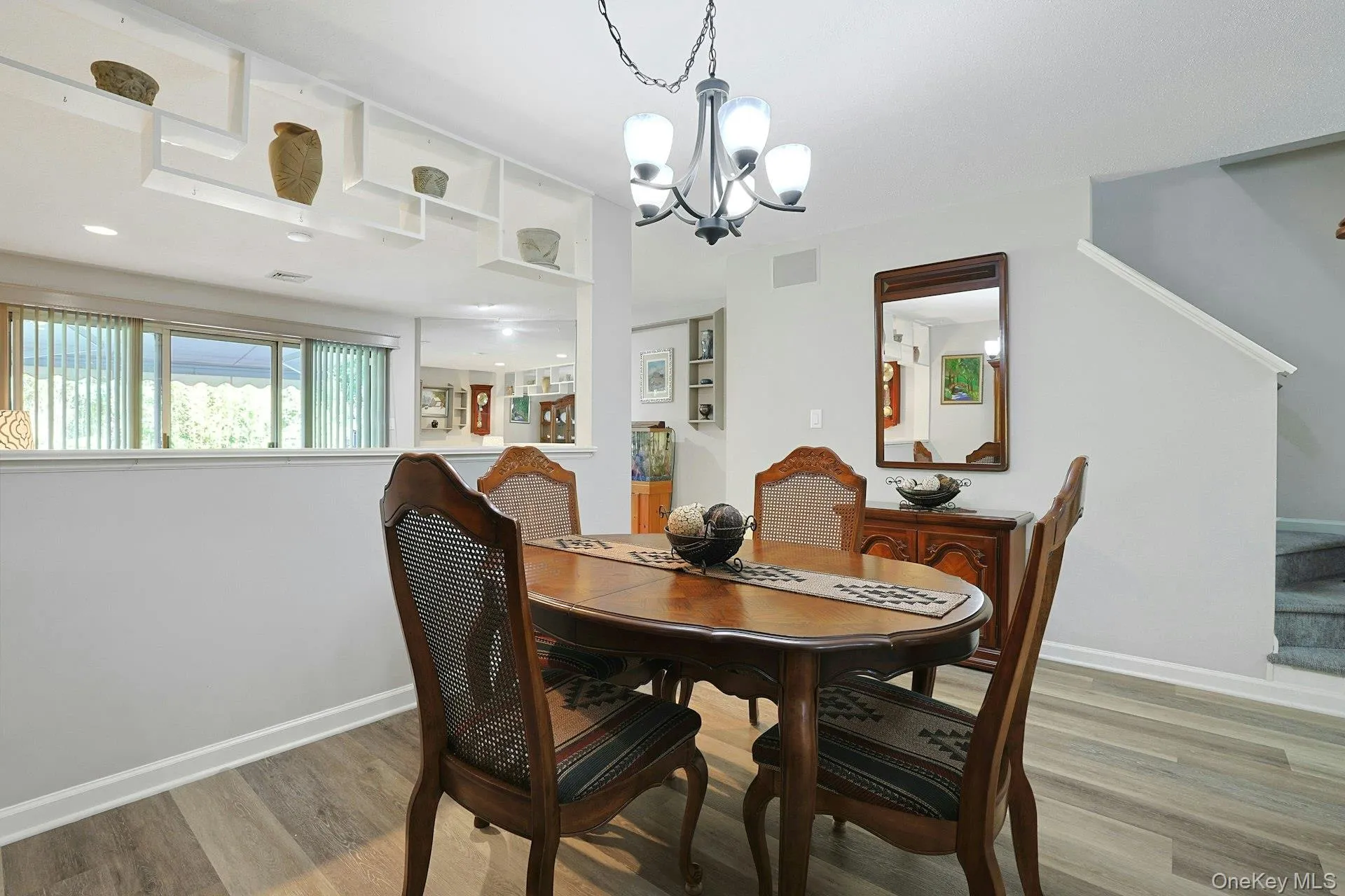 Formal dining room with wood-finish flooring and new chandelier Formal dining room with wood-finish flooring and new chandelier