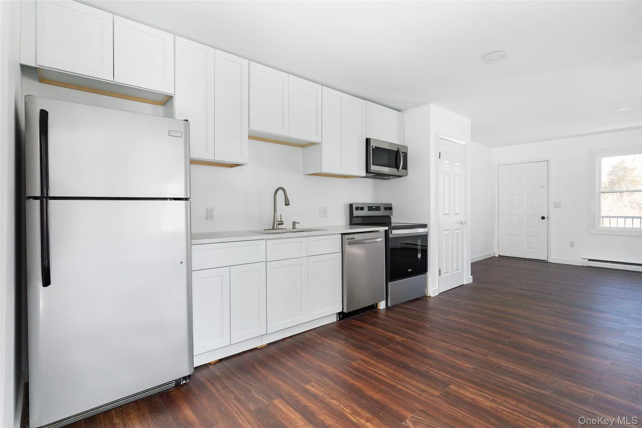 Kitchen with white cabinets, stainless steel appliances, quartz counter and sink Kitchen with white cabinets, stainless steel appliances, quartz counter and sink