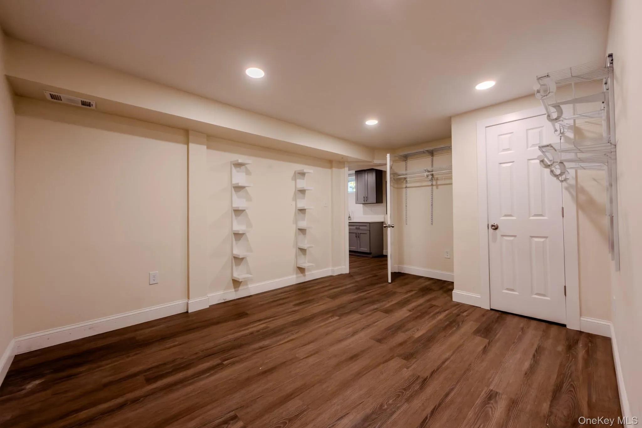 Finished room featuring wood-finish flooring and recessed lighting Finished room featuring wood-finish flooring and recessed lighting