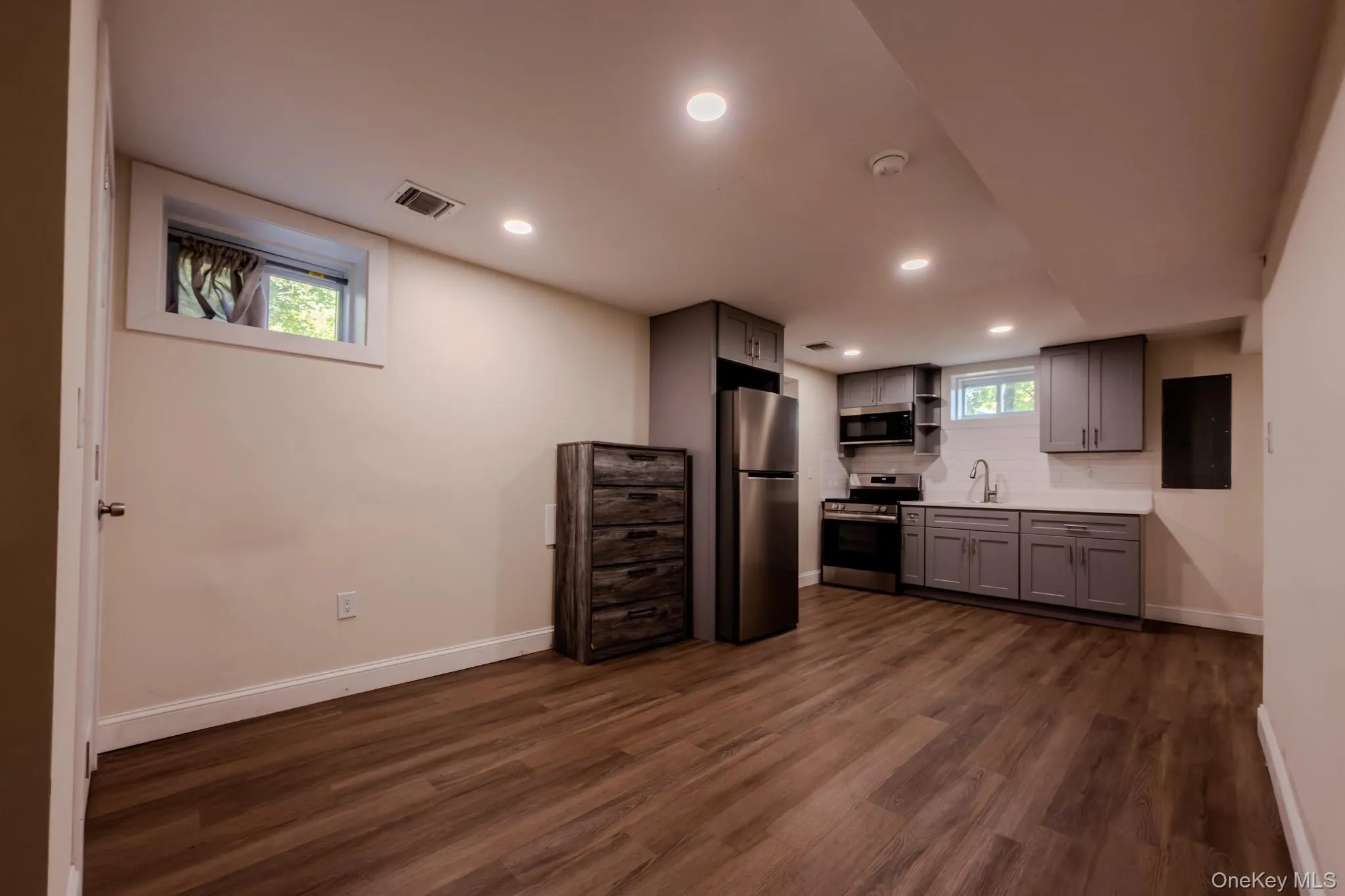 Finished basement with recessed lighting and wood-finish flooring Finished basement with recessed lighting and wood-finish flooring