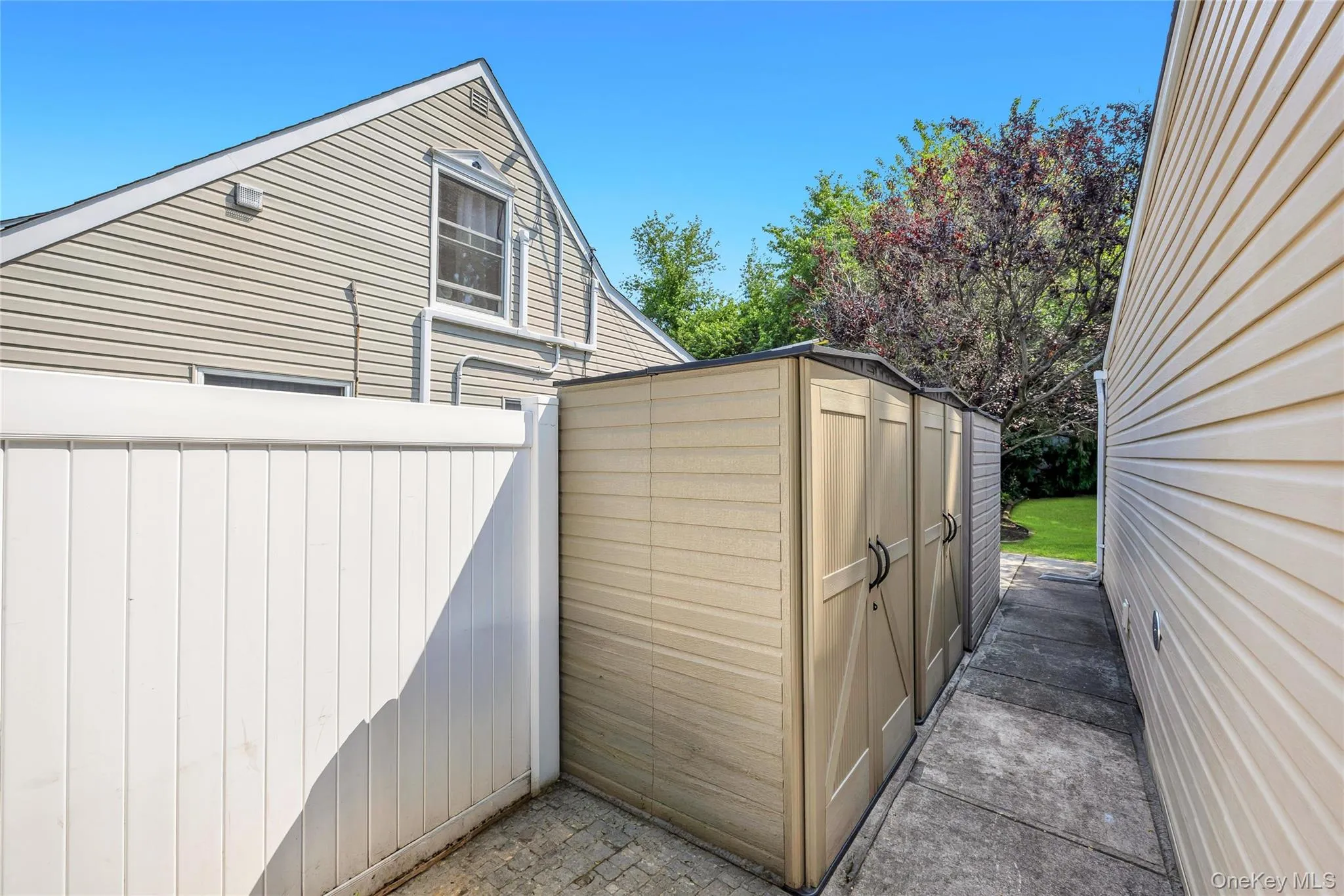 Left rear side of house with 2 storage sheds Left rear side of house with 2 storage sheds