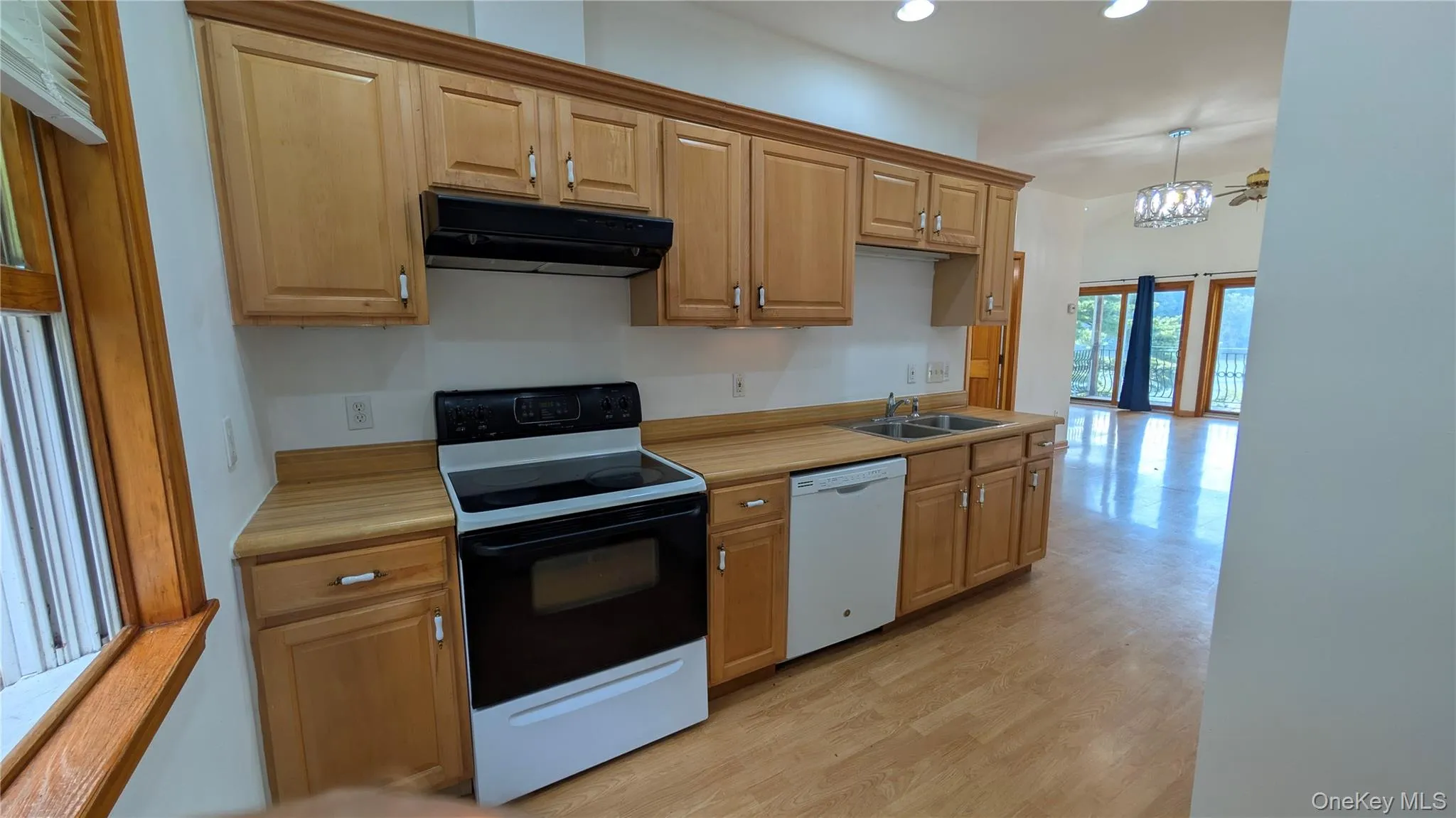 Kitchen featuring black electric range oven, recessed lighting, light countertops, range hood, and dishwasher Kitchen featuring black electric range oven, recessed lighting, light countertops, range hood, and dishwasher