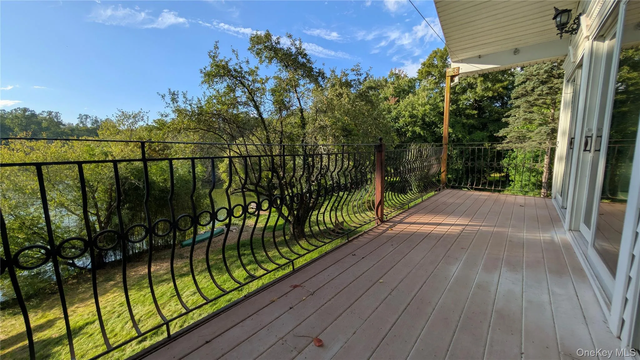 Deck featuring a lawn Deck featuring a lawn