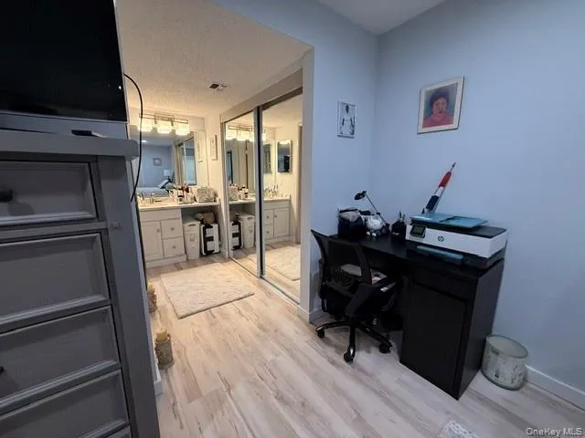 Primary bedroom with sink, vanity, and access to bathroom Primary bedroom with sink, vanity, and access to bathroom