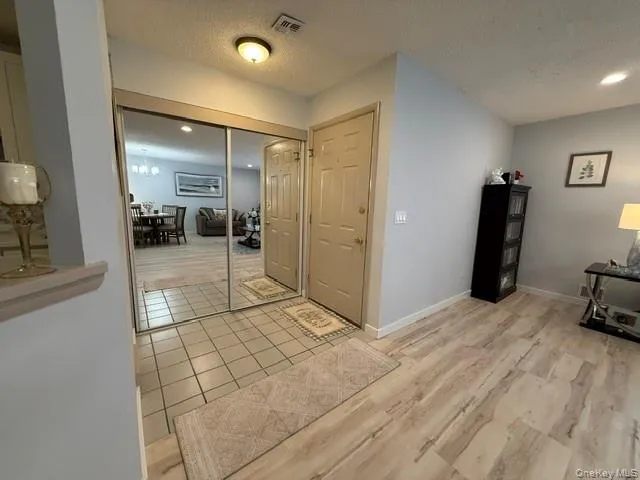 Front door entrance with tile floor and coat closet Front door entrance with tile floor and coat closet