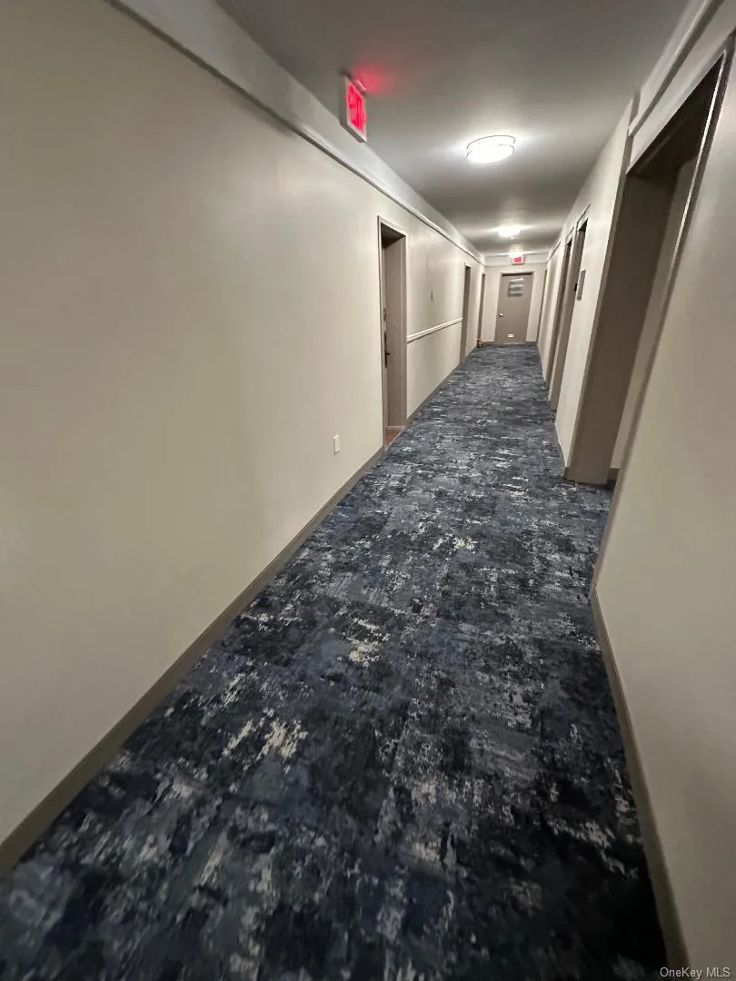 Corridor featuring baseboards Corridor featuring baseboards