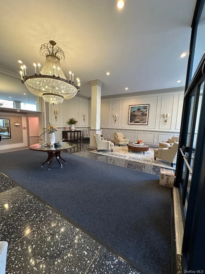 Common area with a decorative wall, ornamental molding, and recessed lighting Common area with a decorative wall, ornamental molding, and recessed lighting