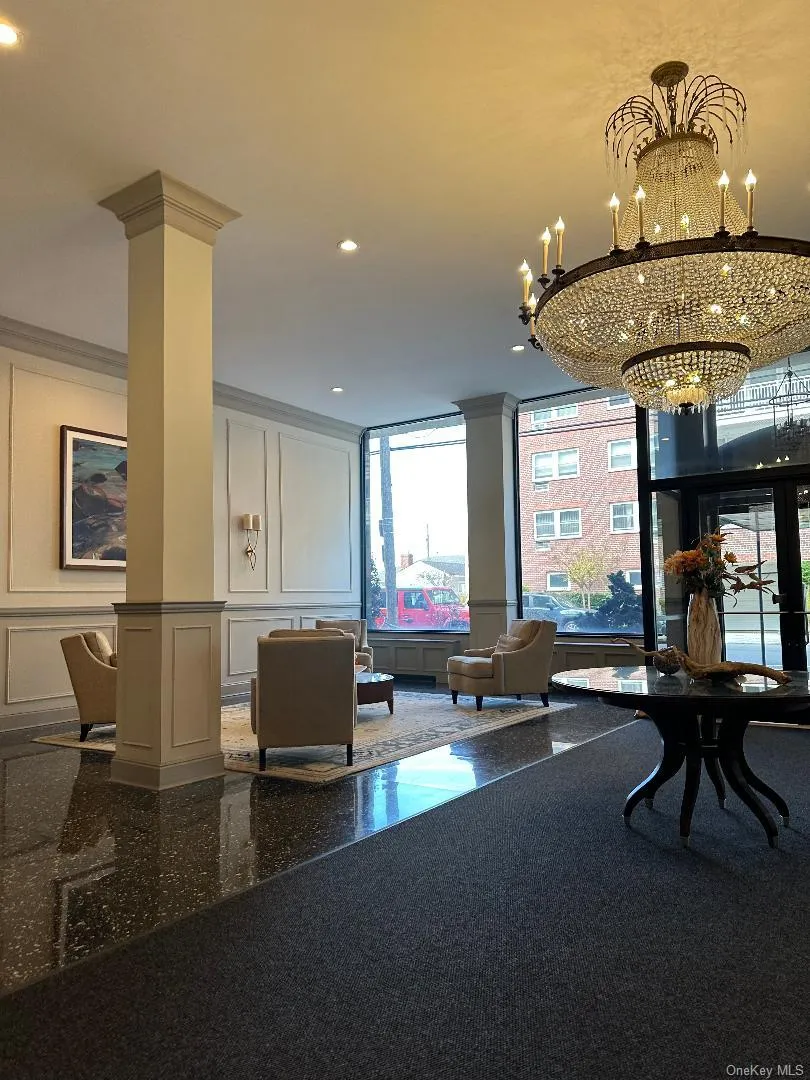 Building lobby featuring a decorative wall, ornamental molding, and recessed lighting Building lobby featuring a decorative wall, ornamental molding, and recessed lighting