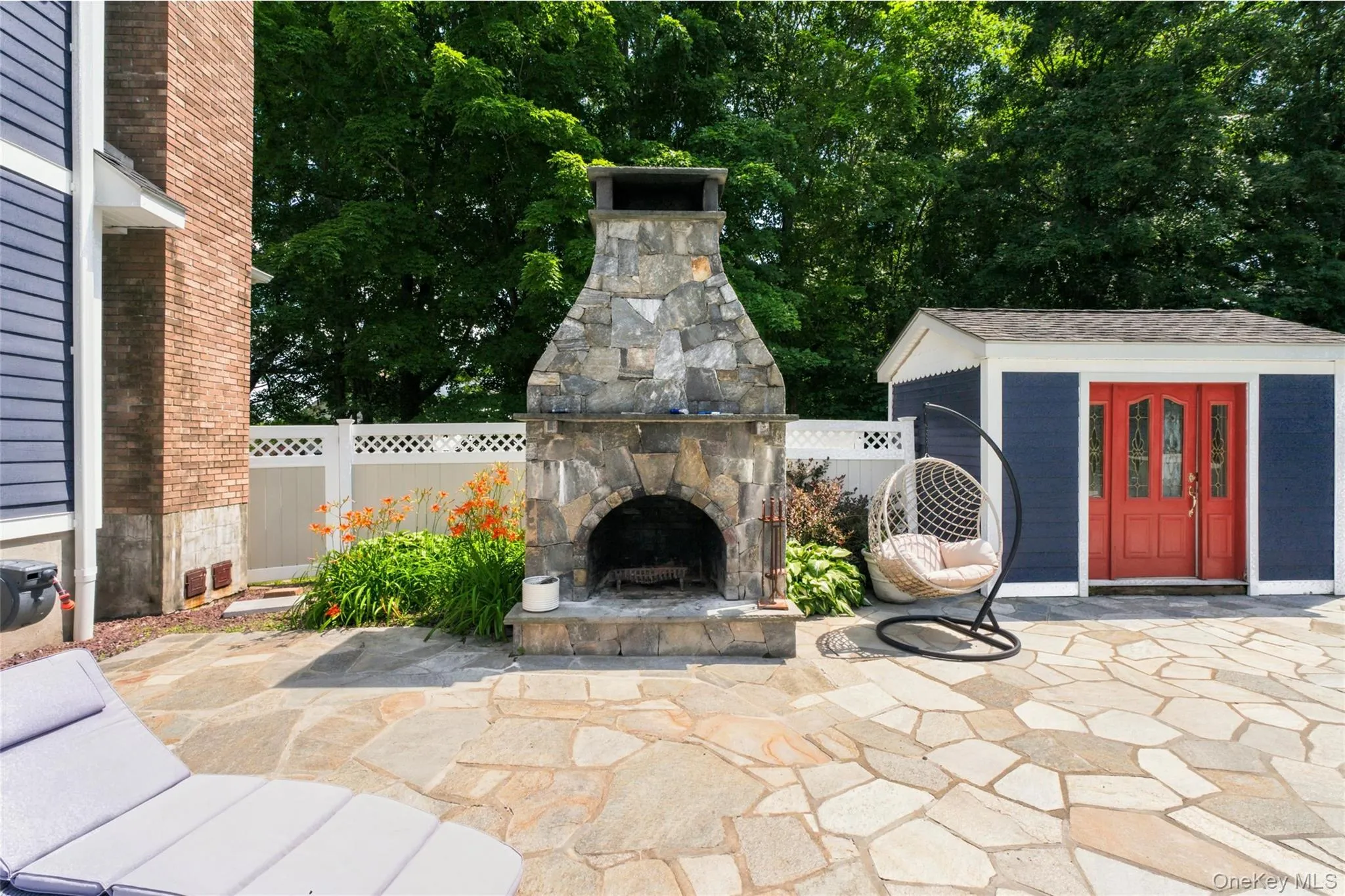 A stunning stone fireplace and cozy seating surrounded by lush landscaping. It’s the perfect spot for relaxing evenings and outdoor gatherings. A stunning stone fireplace and cozy seating surrounded by lush landscaping. It’s the perfect spot for relaxing evenings and outdoor gatherings.