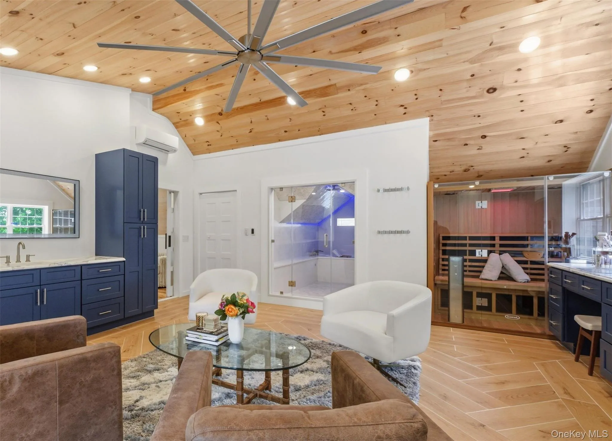 This luxurious wellness retreat brings spa-level relaxation right into the home. The room features a soaring wood-clad ceiling, recessed lighting, quartz countertops, and a stylish seating area. A glass-enclosed steam or shower room, built-in cabinetry with sink, and a beautifully crafted sauna complete the space — perfect for unwinding, recharging, or hosting a serene at-home spa day. This luxurious wellness retreat brings spa-level relaxation right into the home. The room features a soaring wood-clad ceiling, recessed lighting, quartz countertops, and a stylish seating area. A glass-enclosed steam or shower room, built-in cabinetry with sink, and a beautifully crafted sauna complete the space — perfect for unwinding, recharging, or hosting a serene at-home spa day.